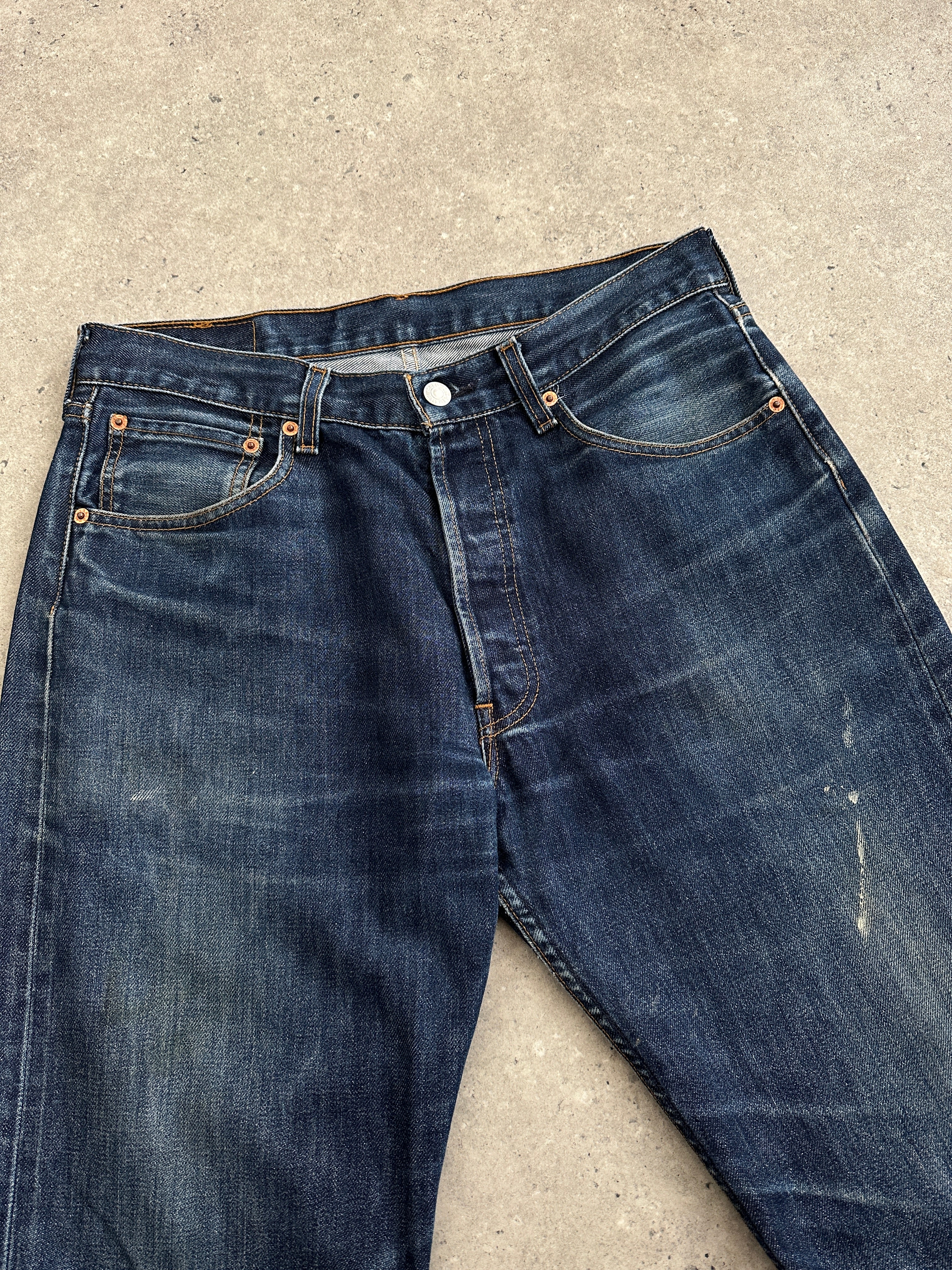 Levi’s 501 distressed straight-leg denim jeans in W30, showing faded denim, distressed details, and classic fit.