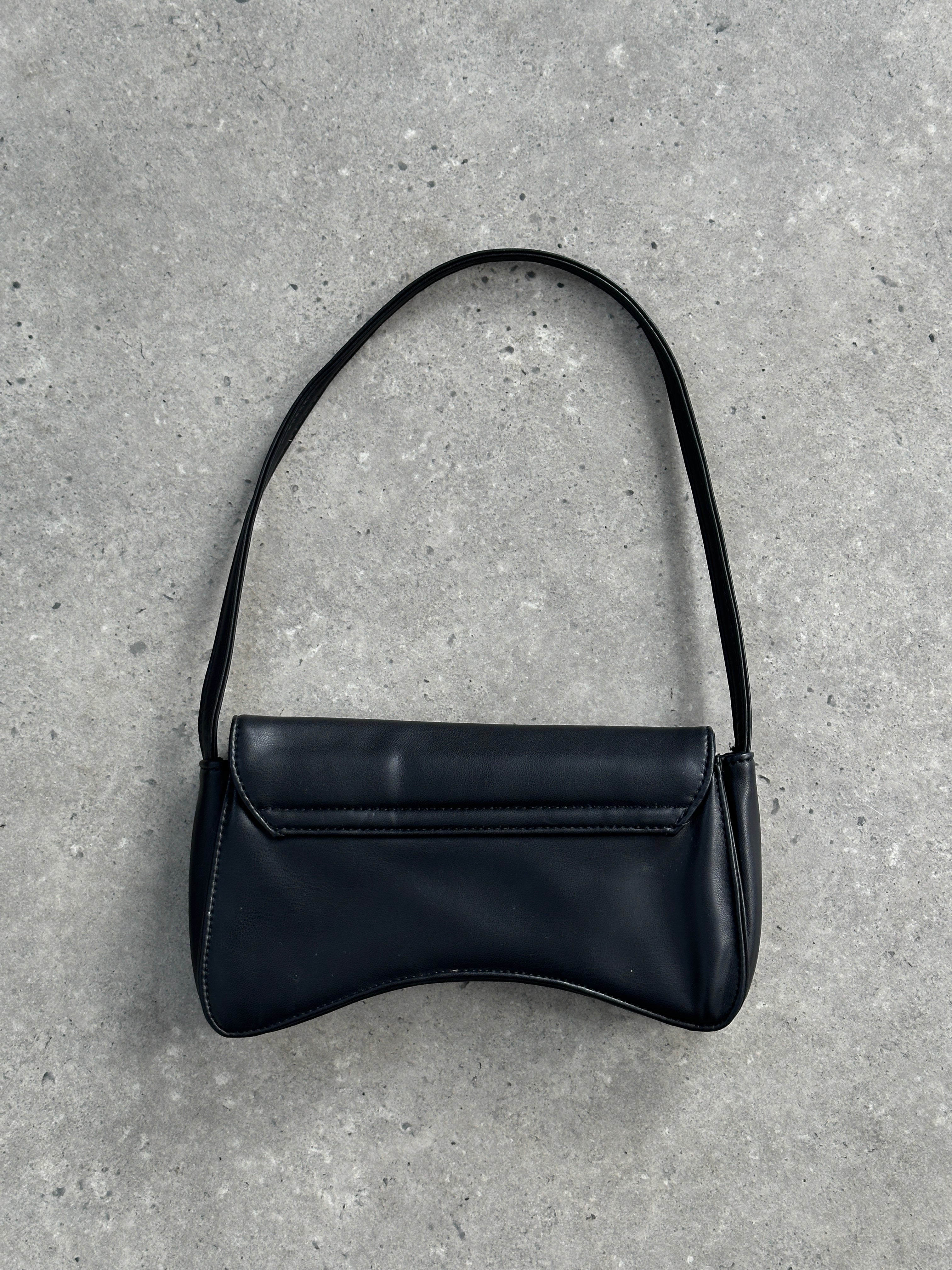 Vintage faux leather curved shoulder bag with adjustable strap and stylish design, perfect for casual and chic outfits.
