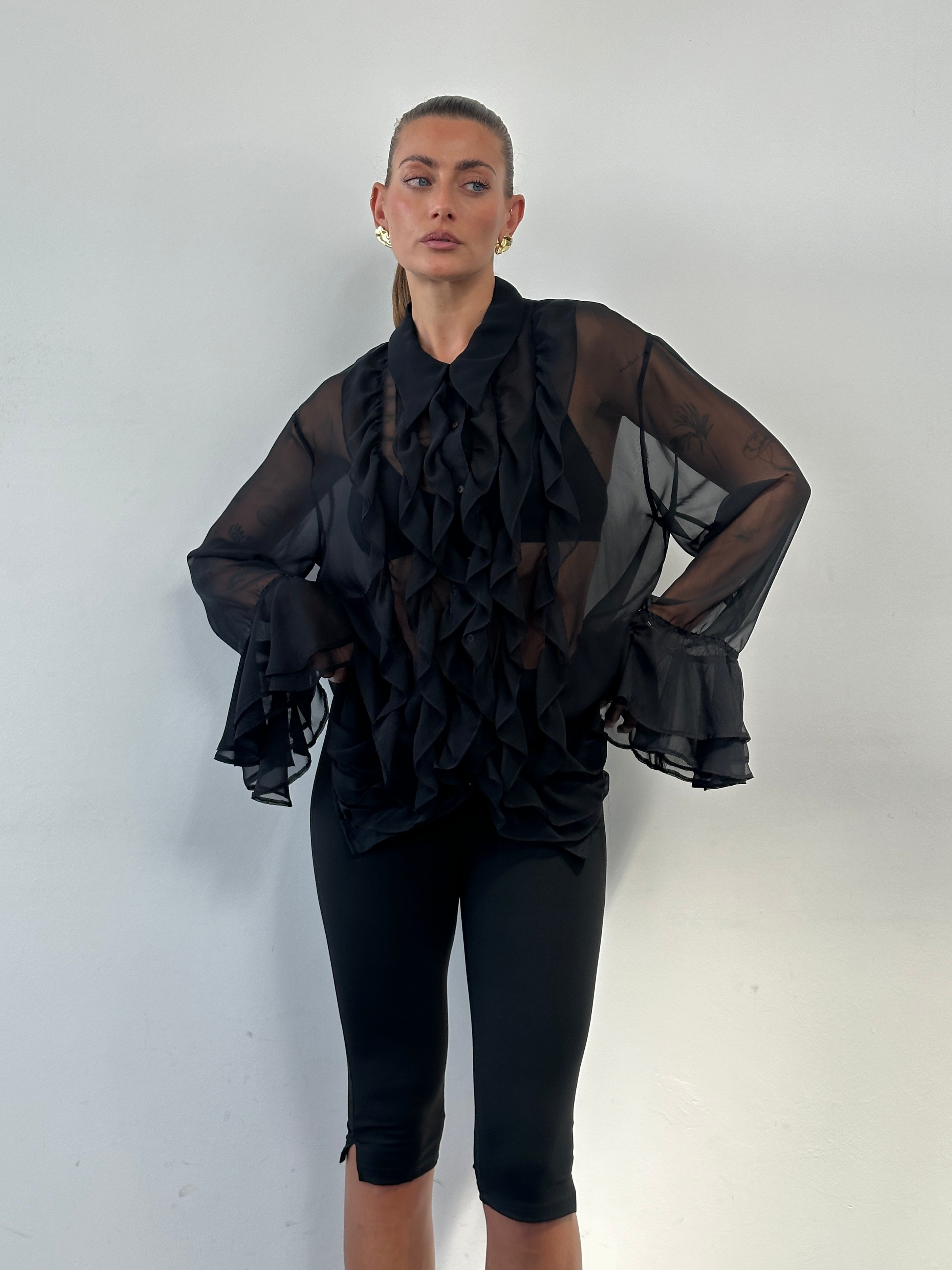 Vintage 00s sheer ruffle shirt in size L/XL, featuring lightweight fabric and feminine ruffle details, styled casually.