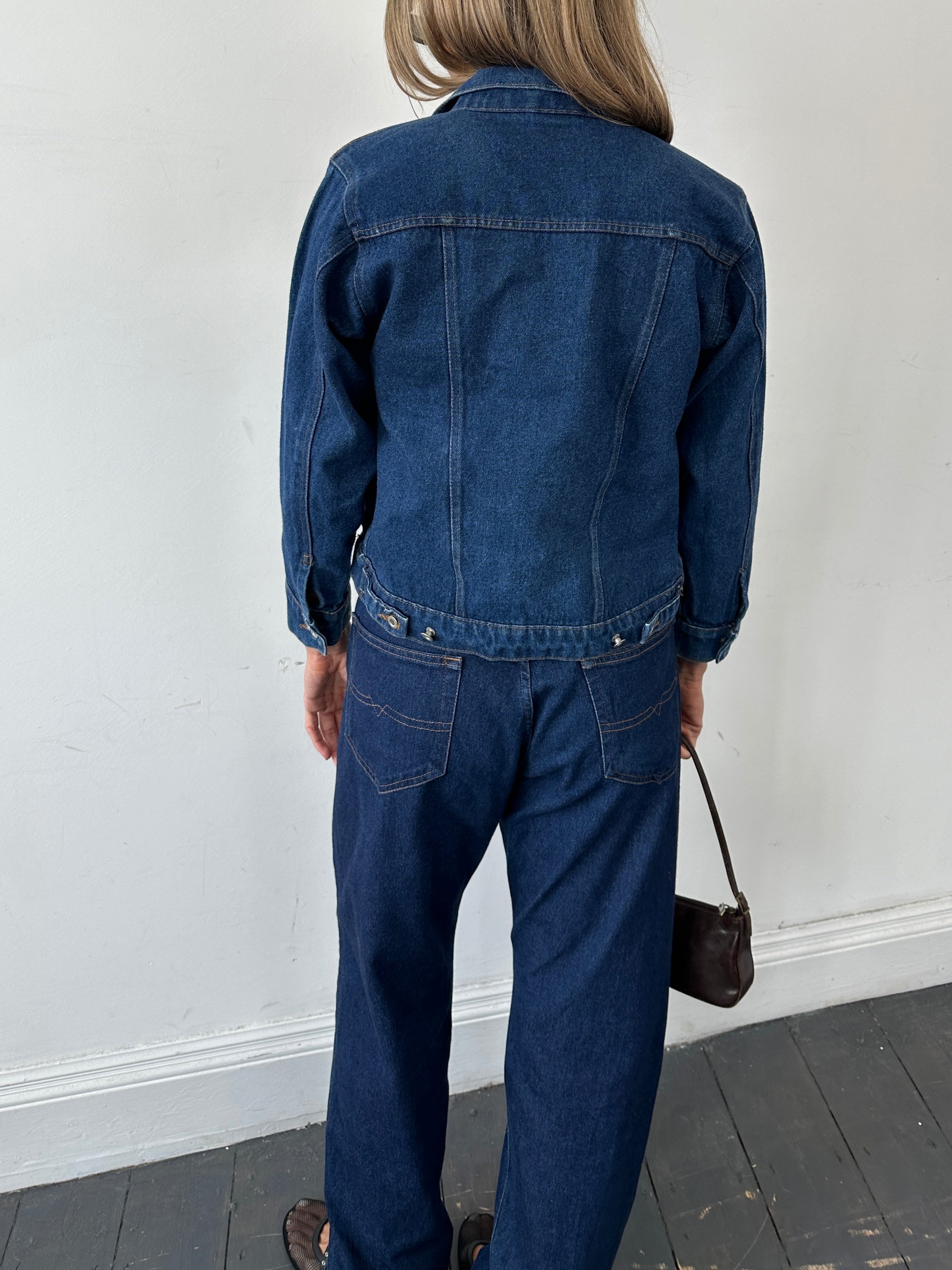 Vintage brand vintage indigo denim jacket, button-up style, in XS/S size, shown on a hanger with visible stitched details.