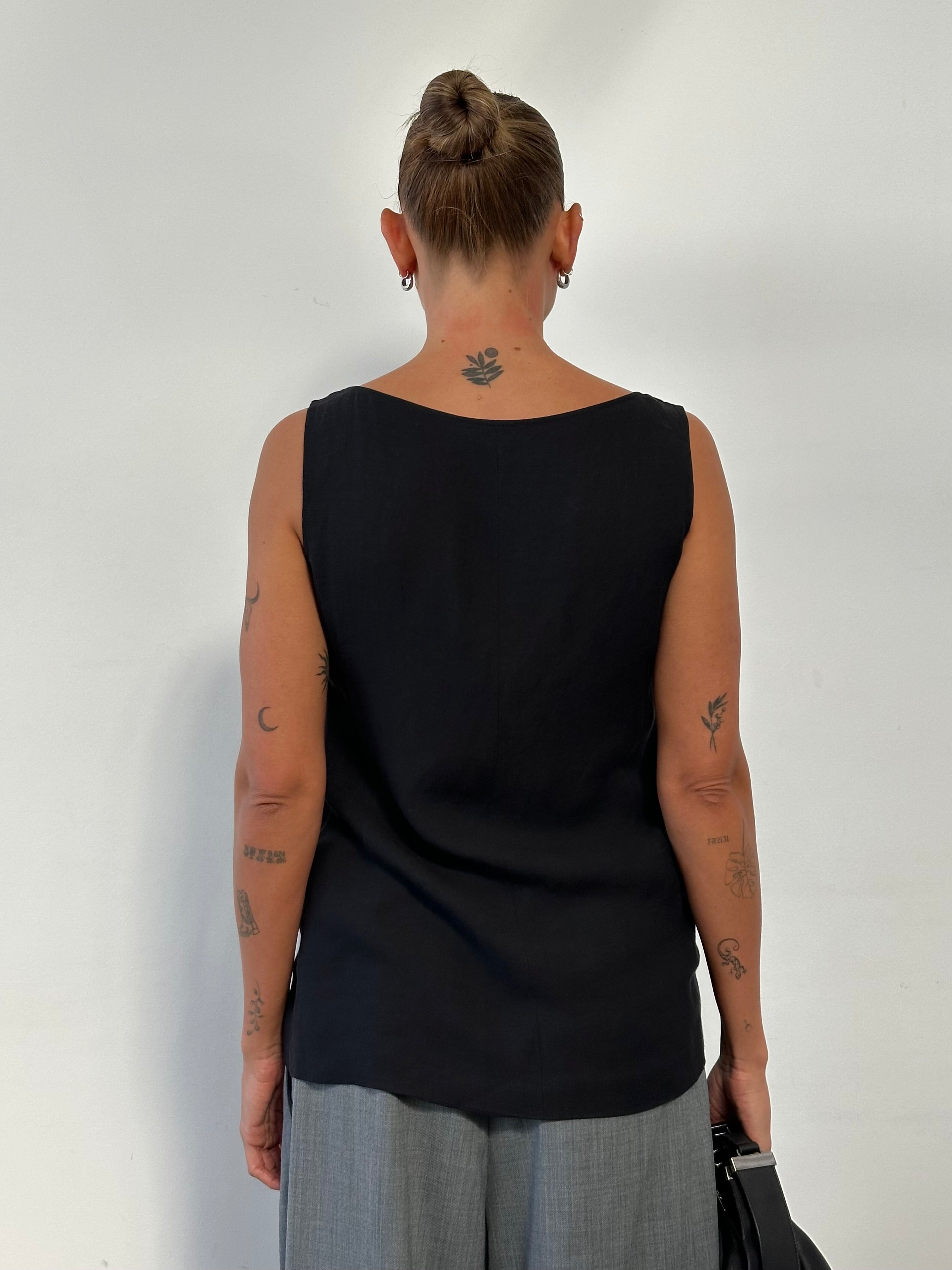 Max Mara linen cowl neck sleeveless tank top in light fabric, shown on a hanger, highlighting its elegant design and soft texture.