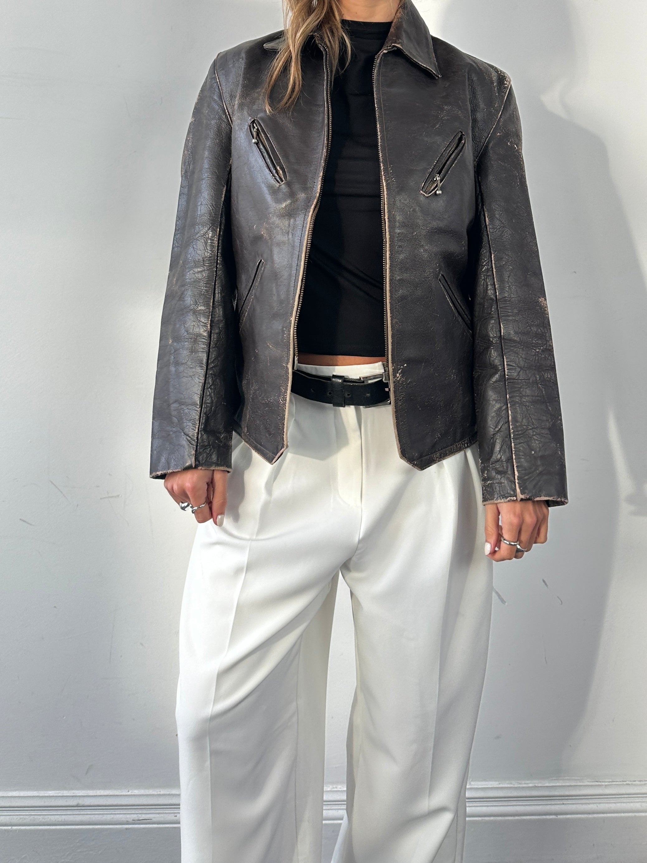 Vintage distressed leather jacket in structured style, size S/M, featuring rugged texture and classic design.
