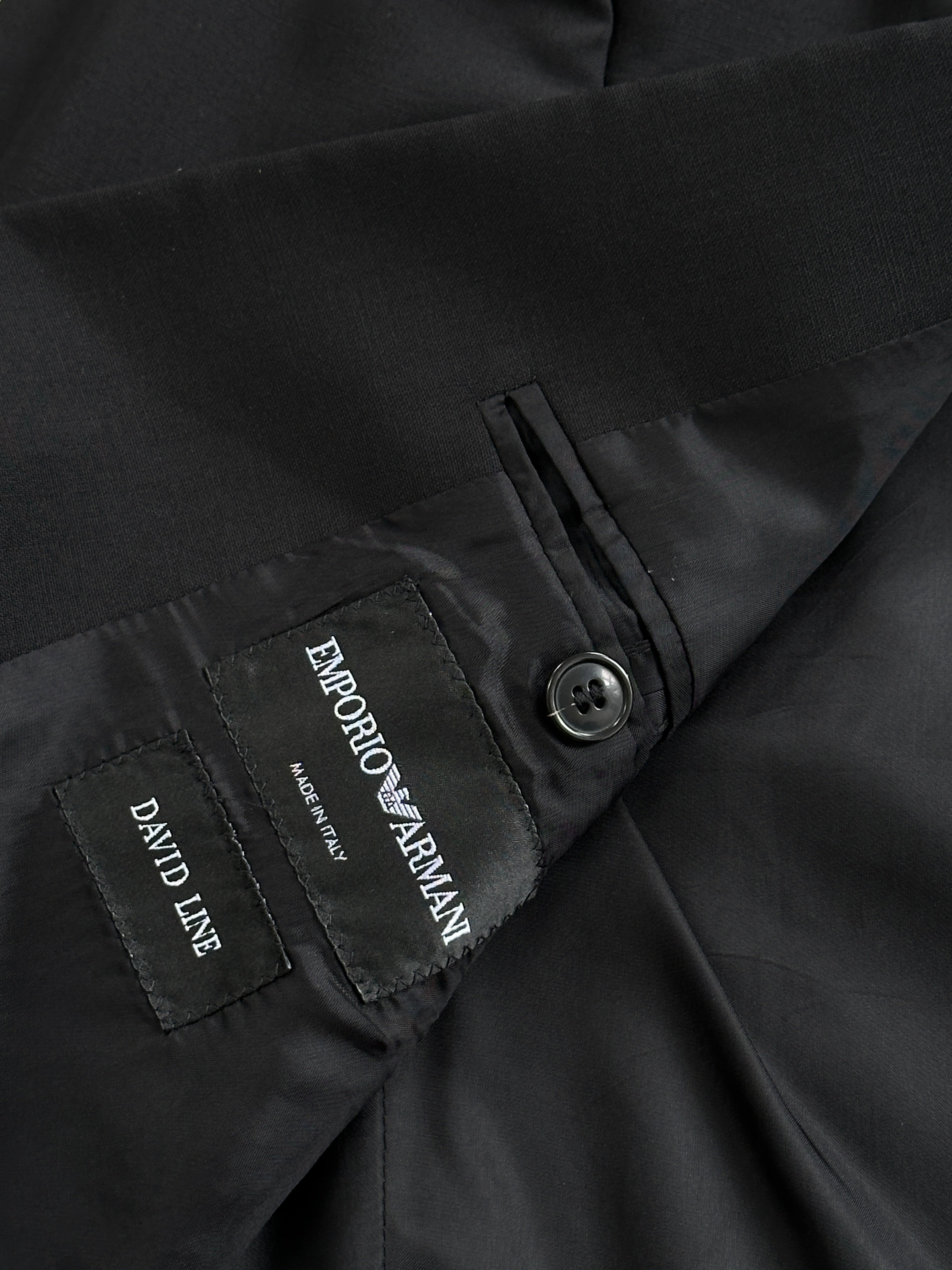 Emporio Armani virgin wool single-breasted blazer in size 38R/M, shown on a hanger with a classic tailored fit.