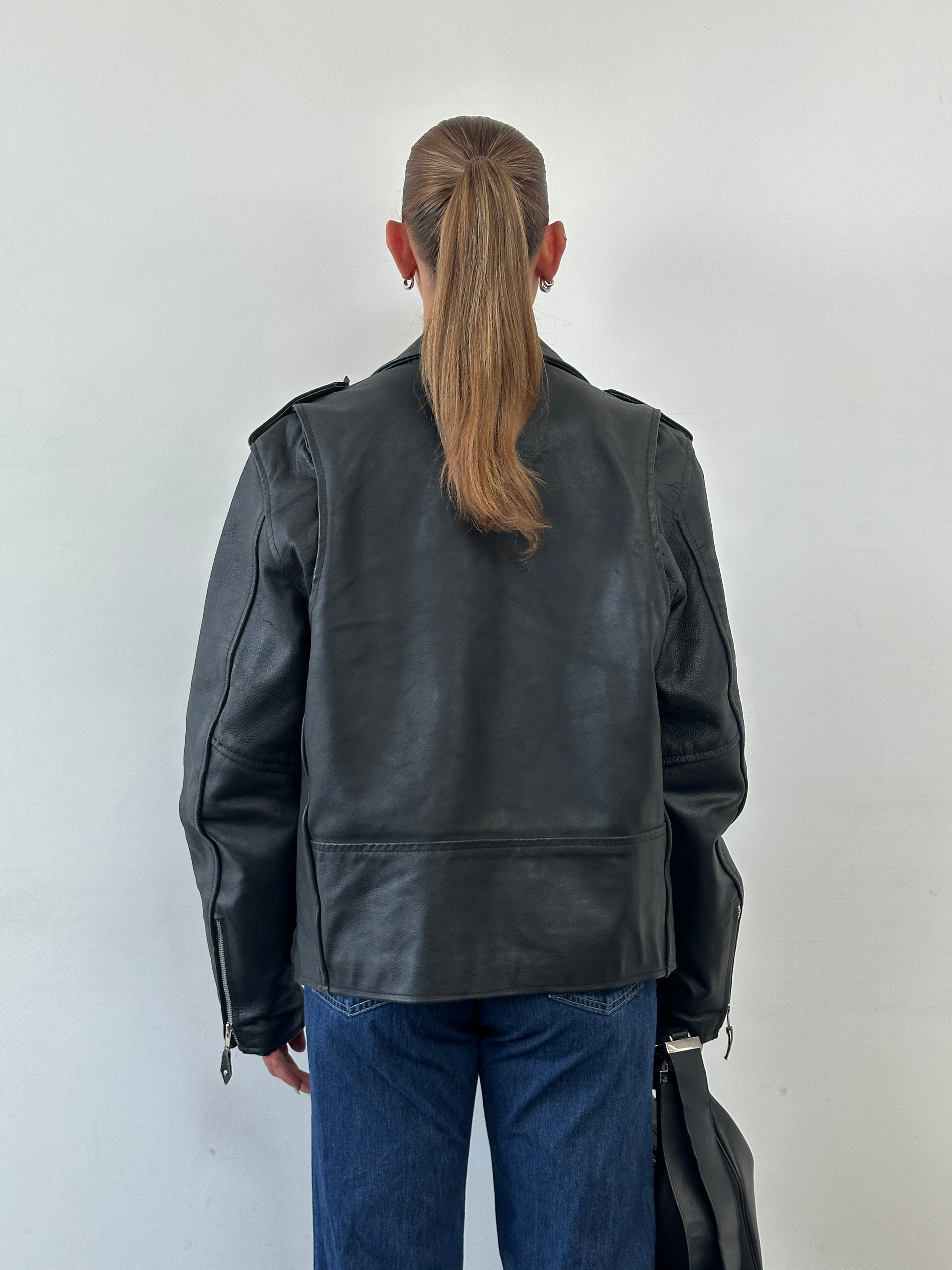 Vintage leather biker jacket in size M/L with classic design, featuring rugged stitching and a distressed finish.