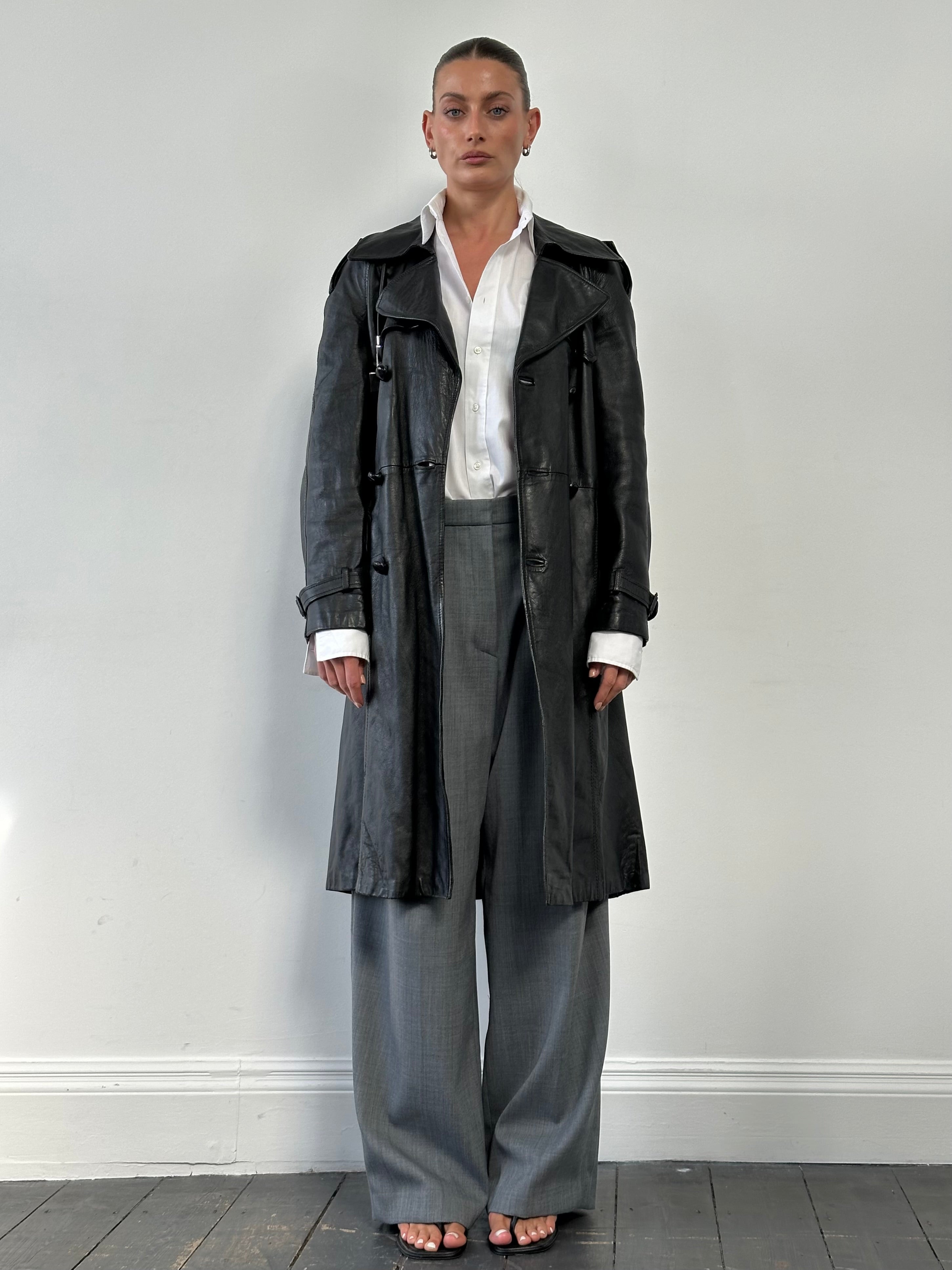 Vintage leather double-breasted belted trench coat, men's size M, with classic style and detailed stitching.