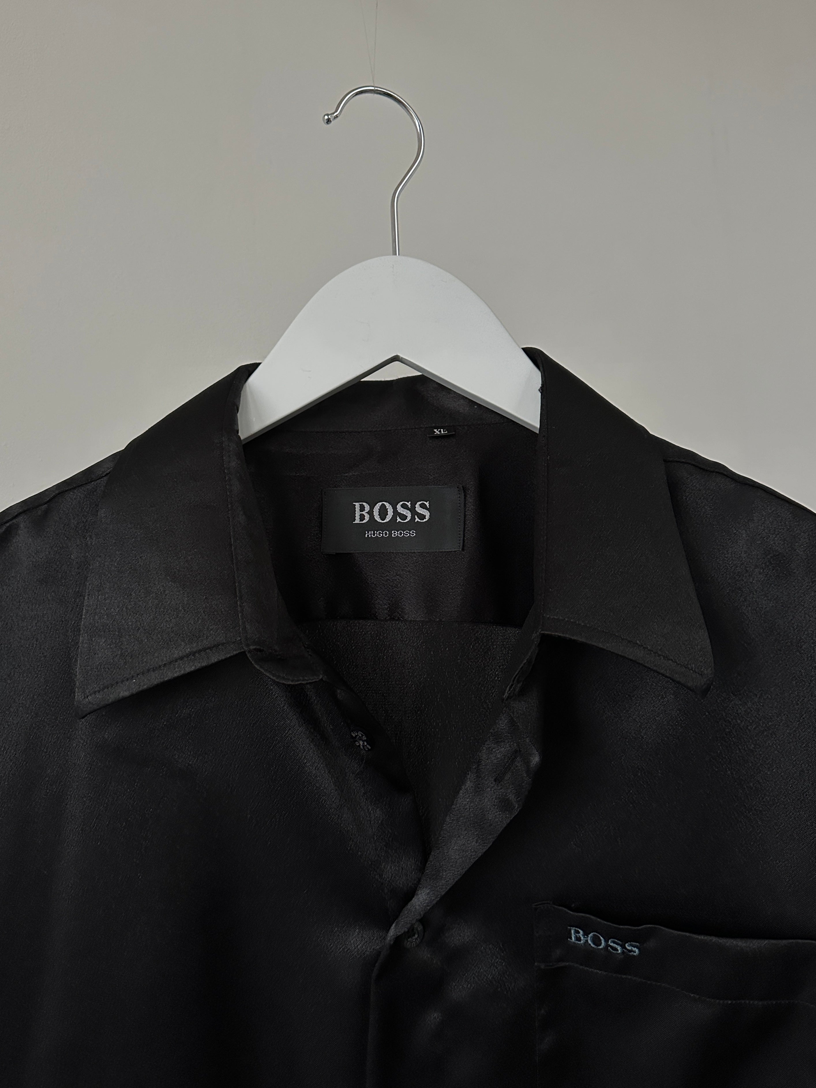 Hugo Boss satin logo shirt in XL, featuring a sleek satin fabric with the brand's logo on the front, displayed on a hanger.
