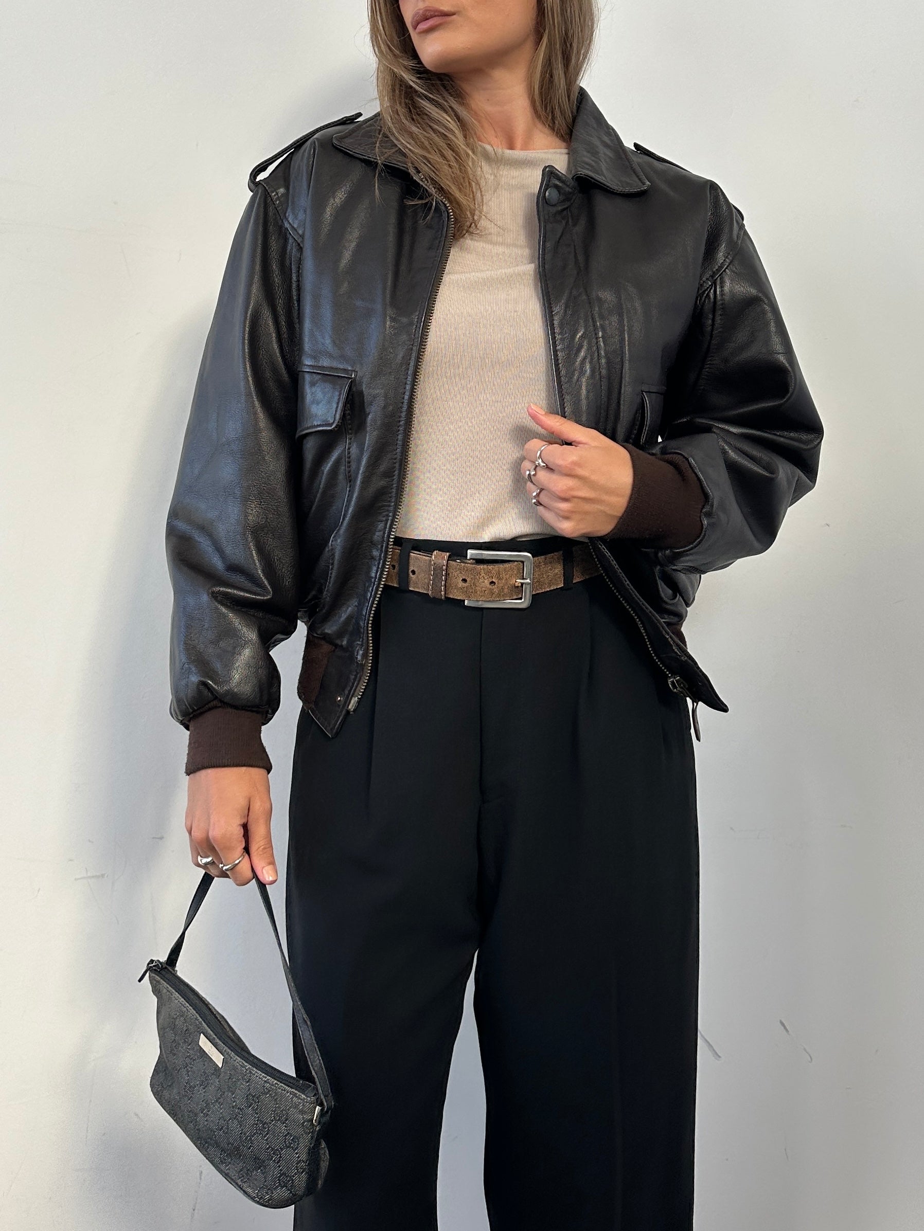Vintage leather bomber jacket with removable faux fur lining, size S/M, featuring classic style and zip closure.
