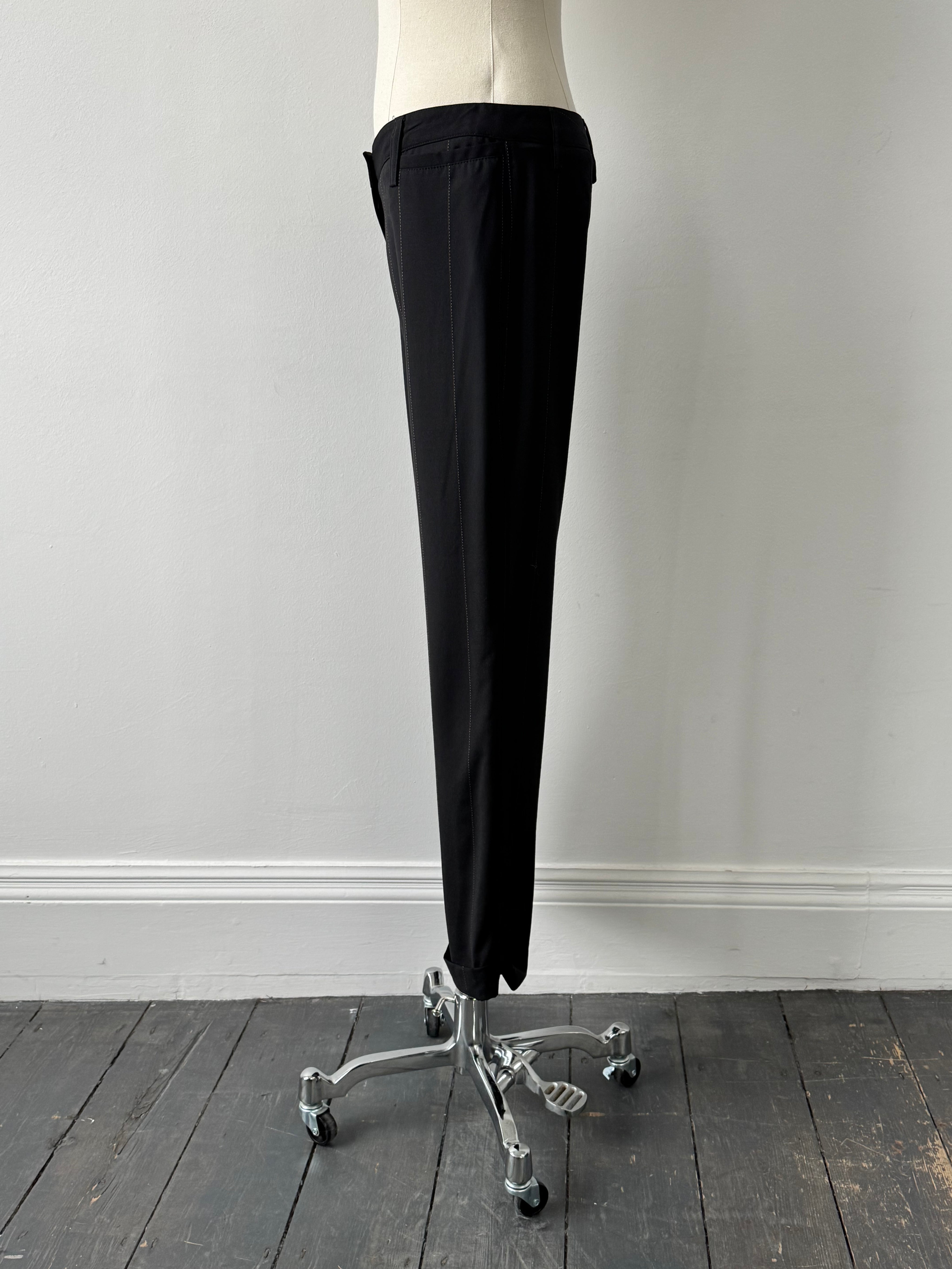 Dolce & Gabbana 2000s wool trousers in black, tailored fit, W28, displayed on a hanger with a plain background.