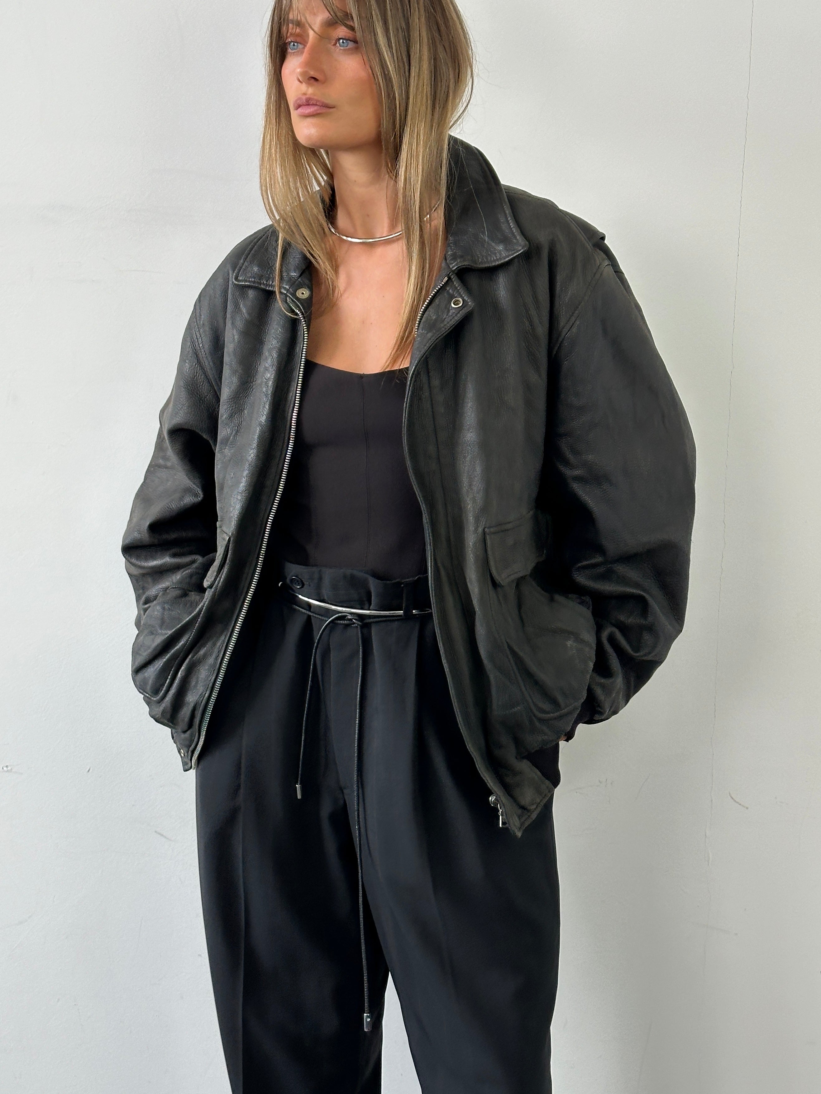 Vintage Italian aged leather bomber jacket in XL, showing classic design, distressed leather, and rugged style.
