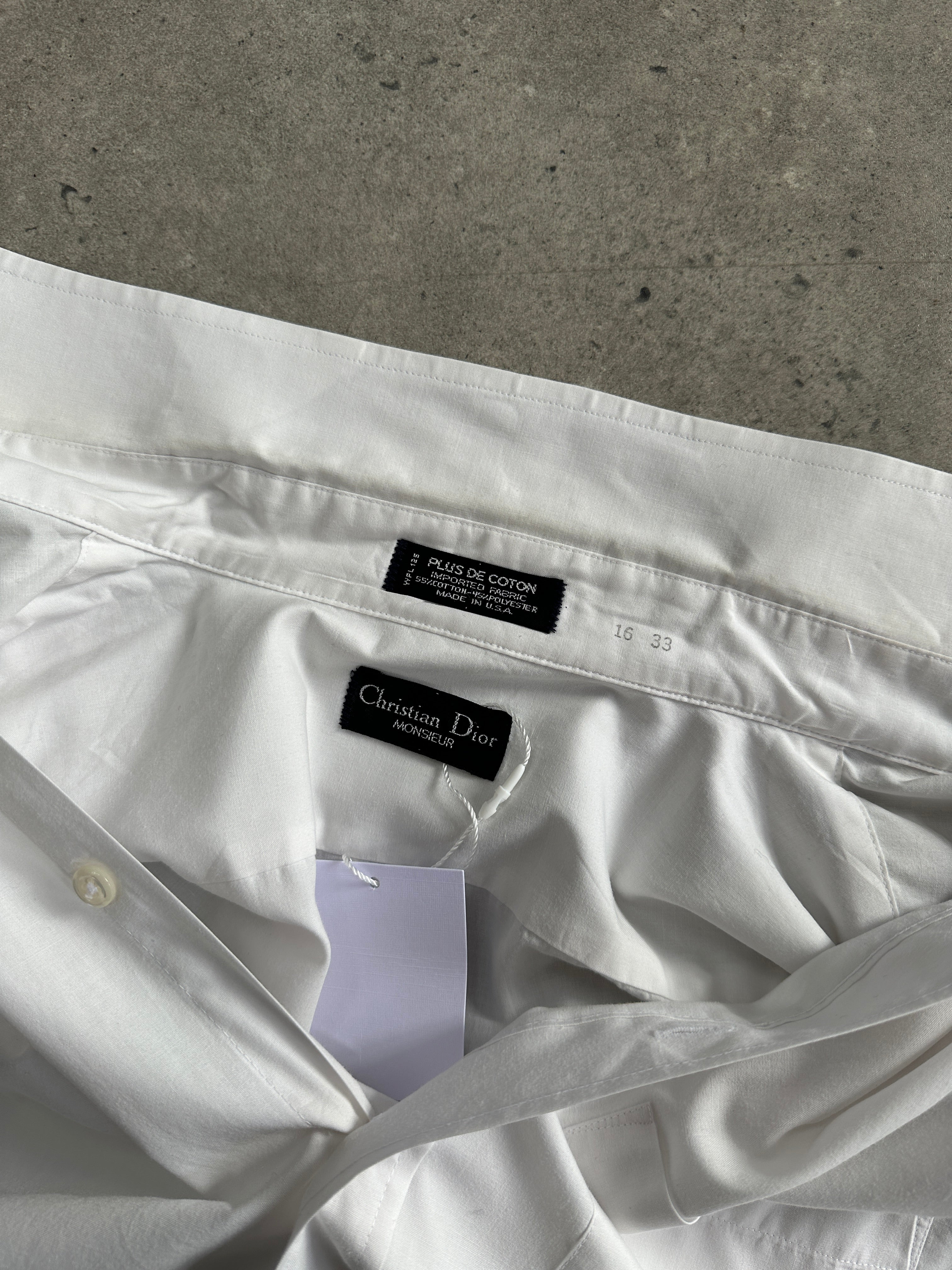 Christian Dior Monsieur cotton dress shirt in size L, featuring a classic collar and button-front design, made of crisp white cotton fabric.