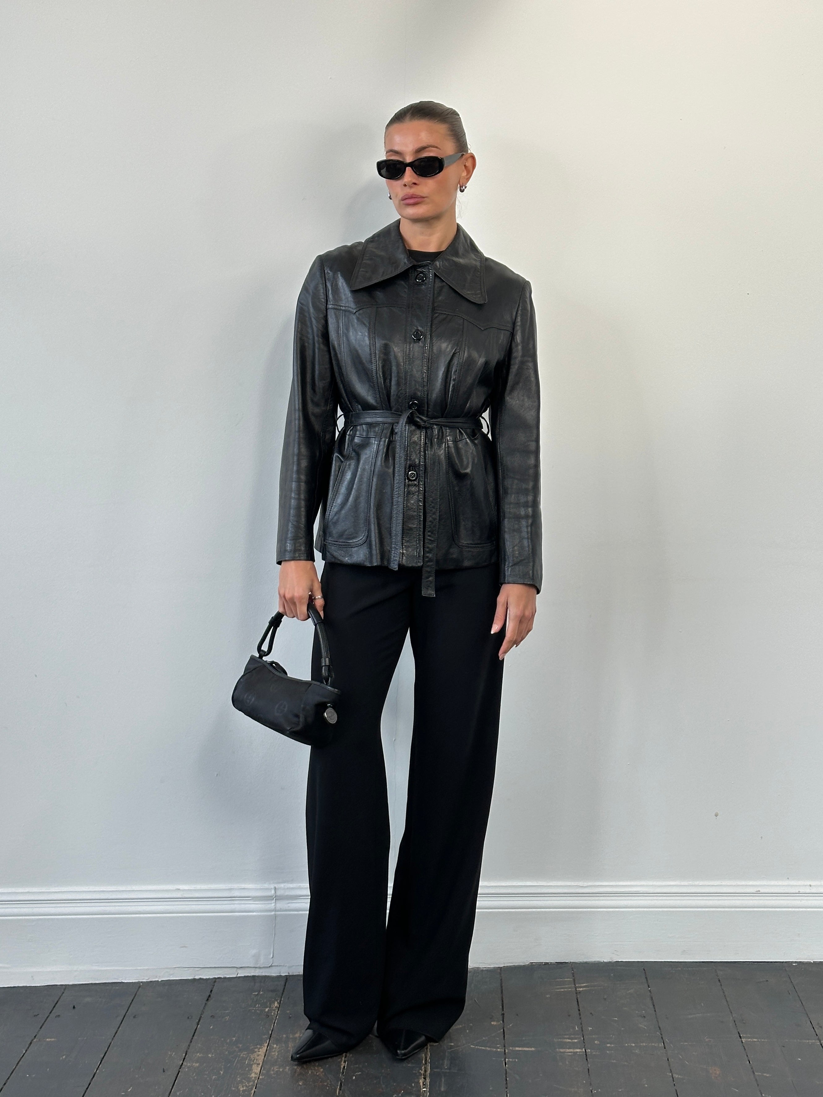 Vintage 1990s leather jacket with dagger collar and belted design, size M, featuring classic vintage leather styling.