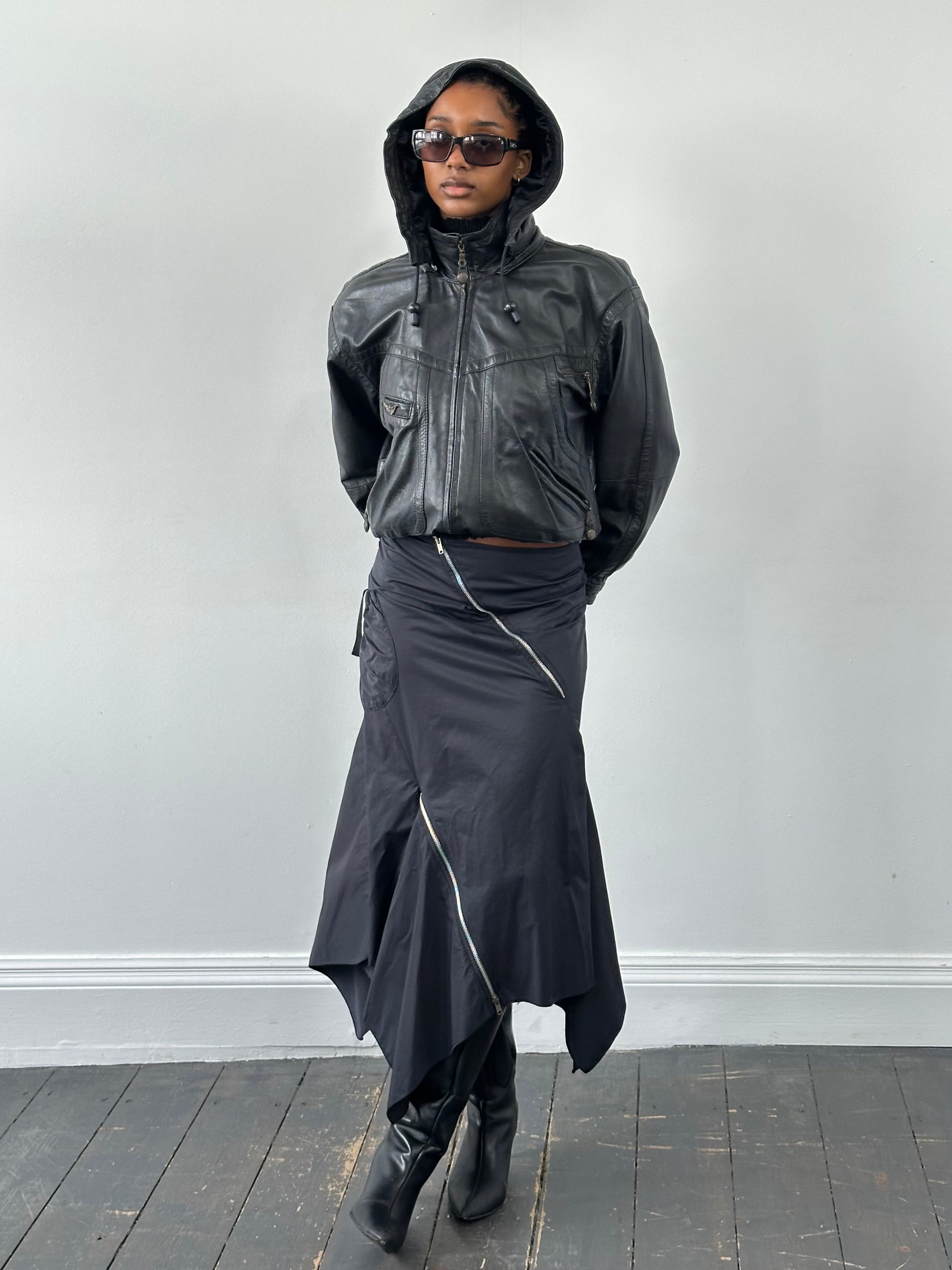 Vintage 1990s leather funnel neck hooded bomber jacket, size small, featuring classic leather texture and hooded design.