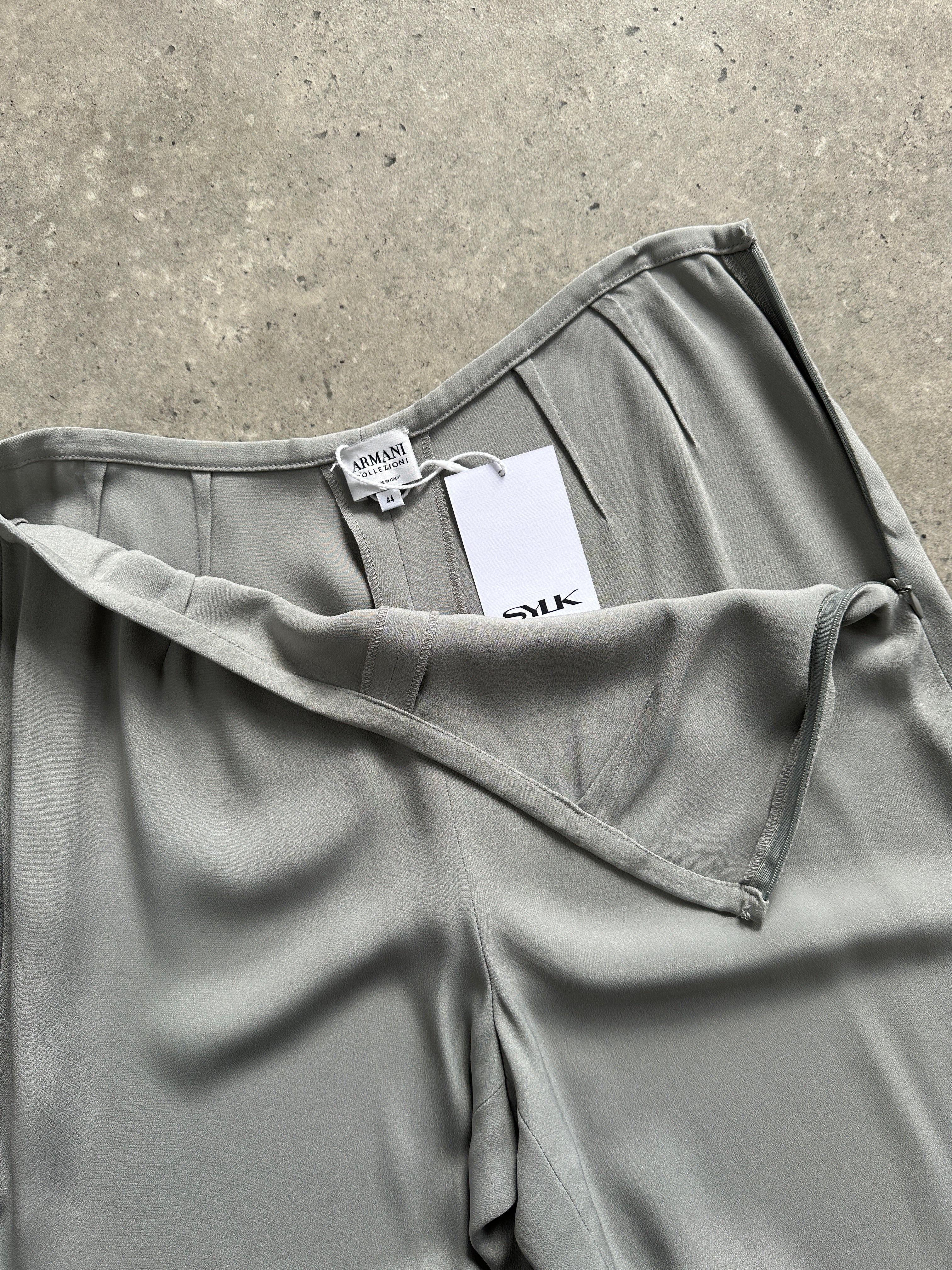 Armani Collezioni relaxed high-waisted silk trousers in size W28, showcasing smooth fabric and tailored fit.