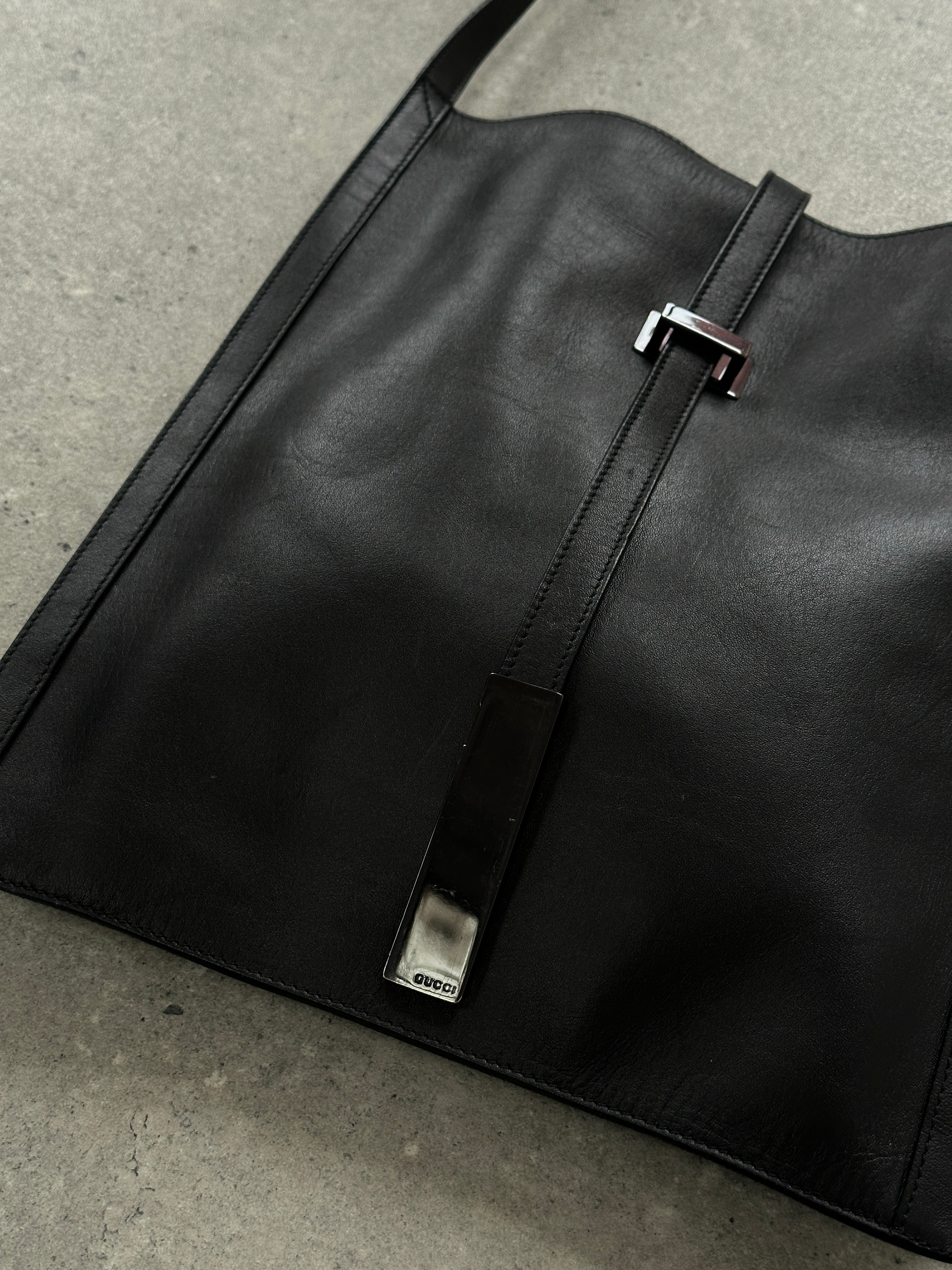 Gucci minimal rectangle leather bag with sleek design and subtle branding, featuring smooth leather and a structured silhouette.