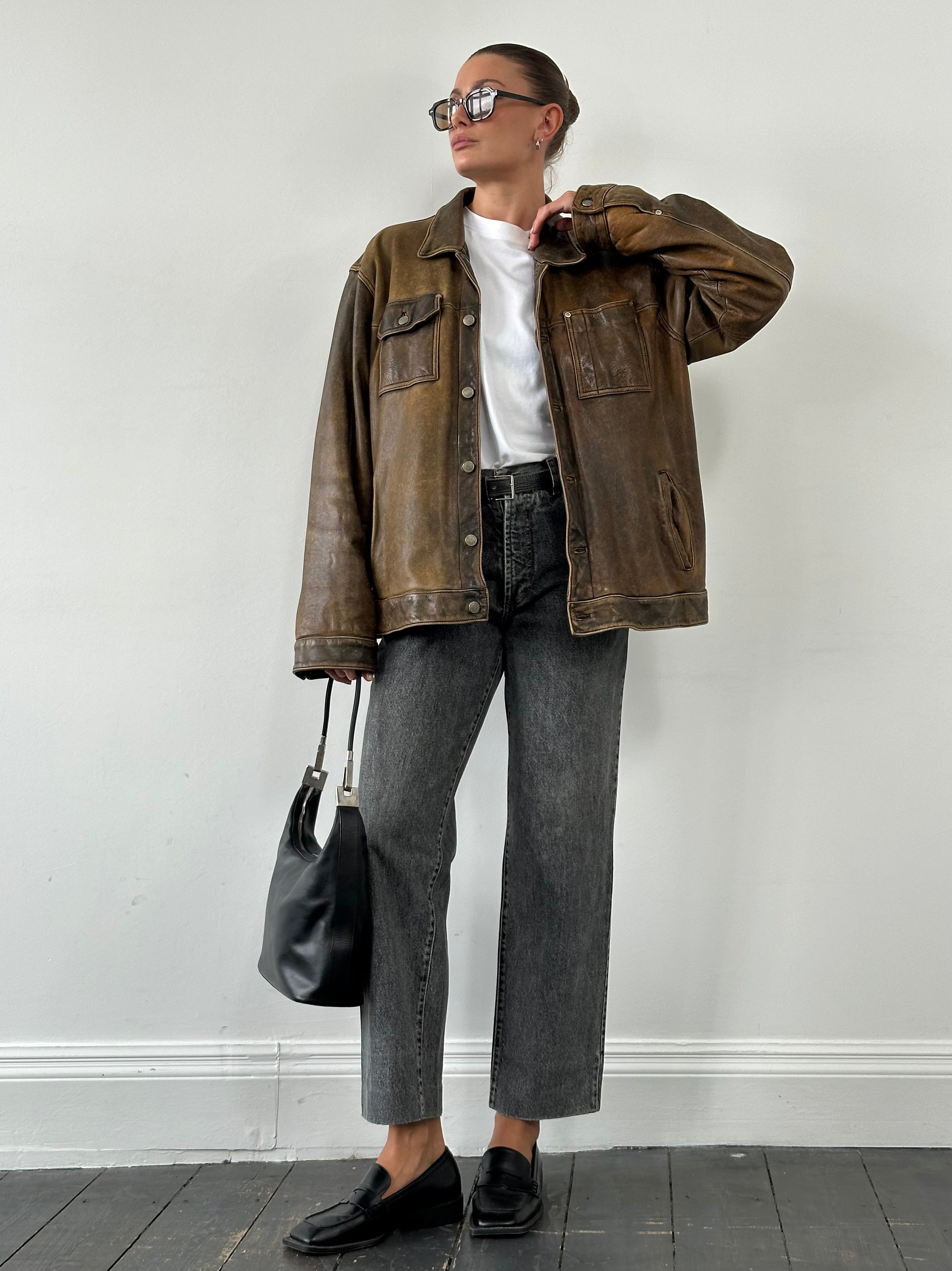 Vintage aged leather trucker jacket in XL with classic design and distressed finish, featuring a rugged, timeless style.