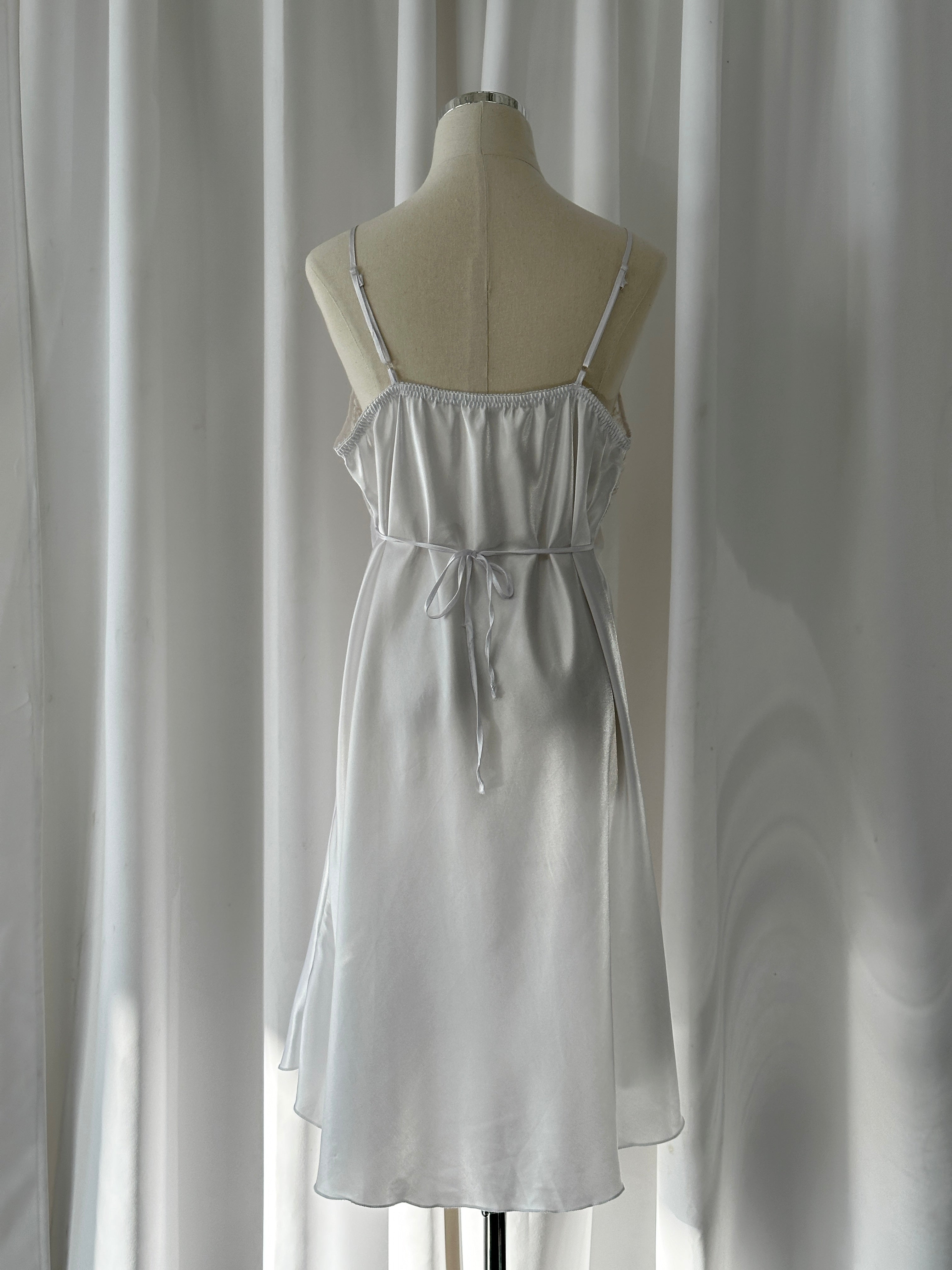 Vintage 1990s lace sheer mini slip dress with delicate details, fitting M/L, featuring a classic retro design and lightweight fabric.