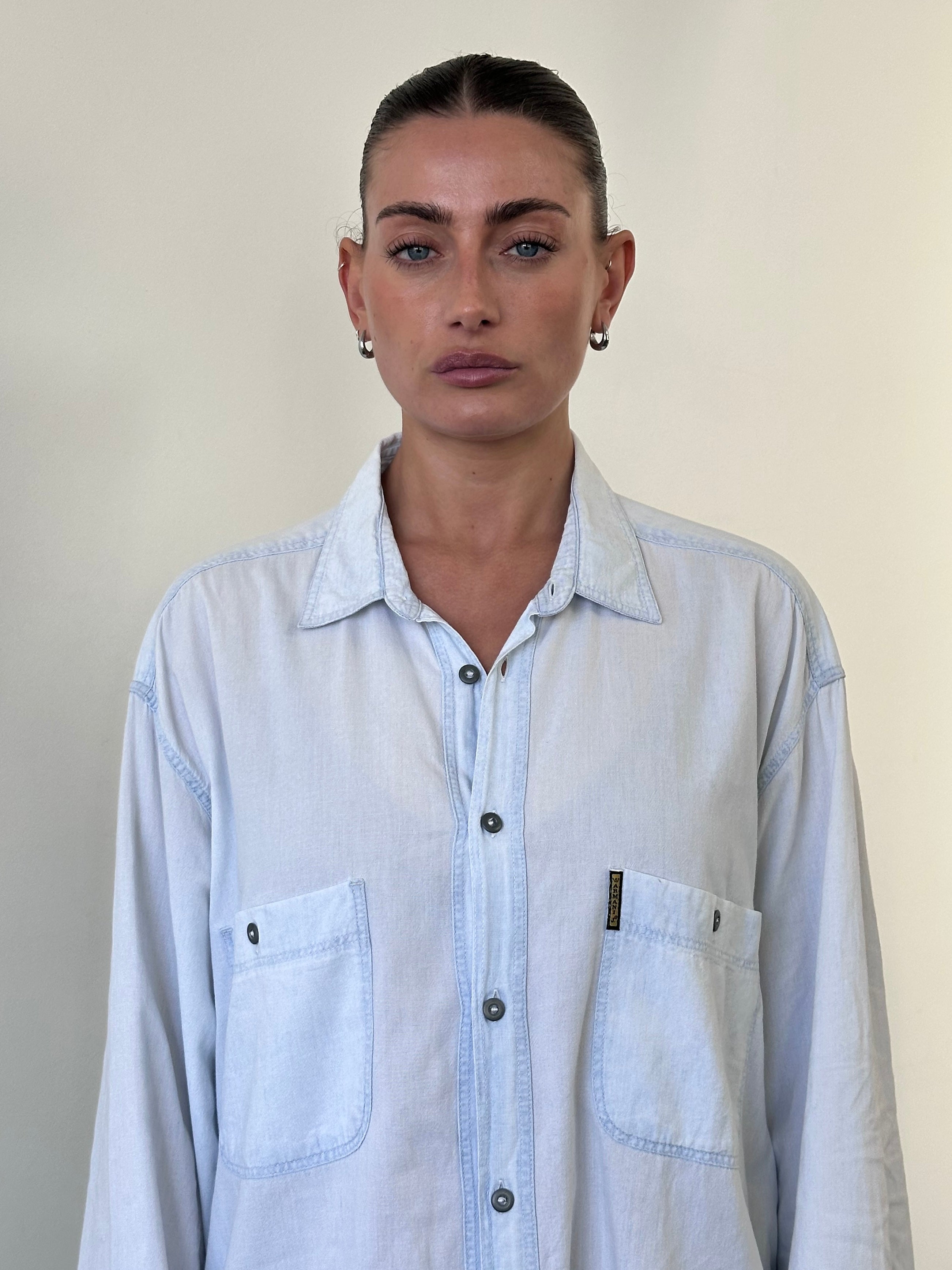 Armani Jeans light wash denim shirt in size XL, casual long-sleeve shirt with button closure and classic denim styling.