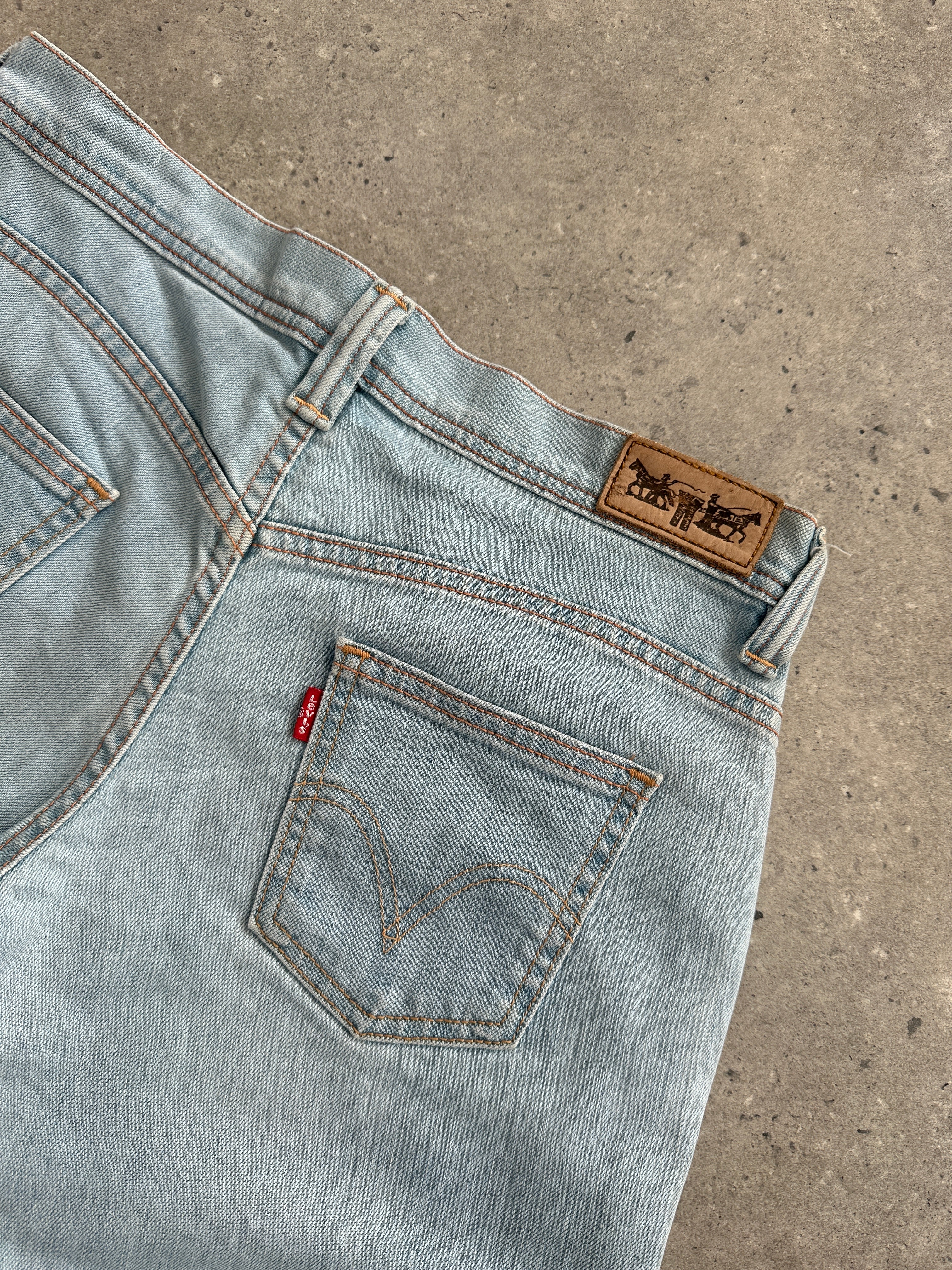 Levi’s low waist flared denim jeans in size W28, showing the classic blue denim with flared leg style.