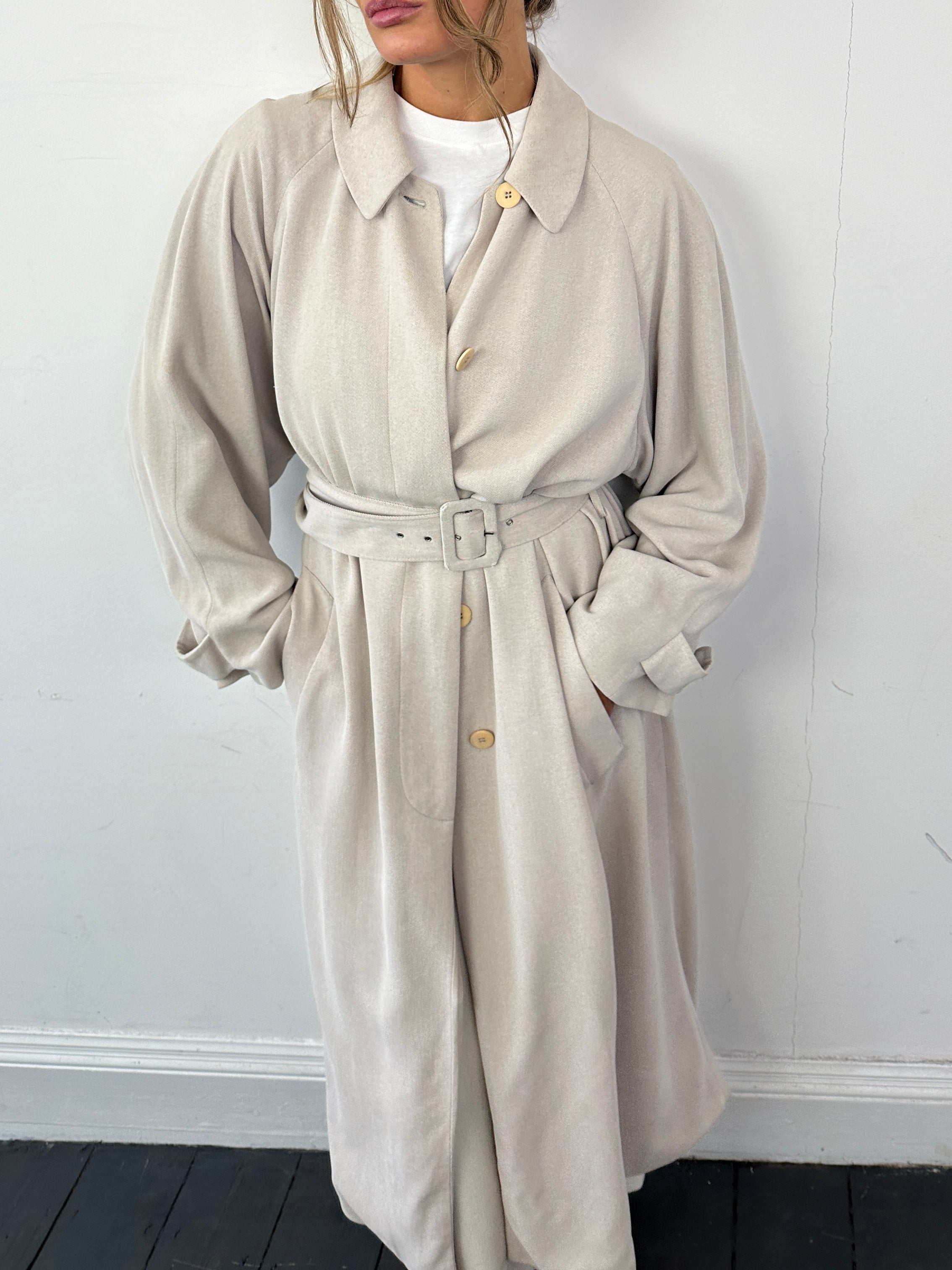 Giorgio Armani Le Collezioni wool floor-length belted coat in beige, featuring a classic collar and elegant design.
