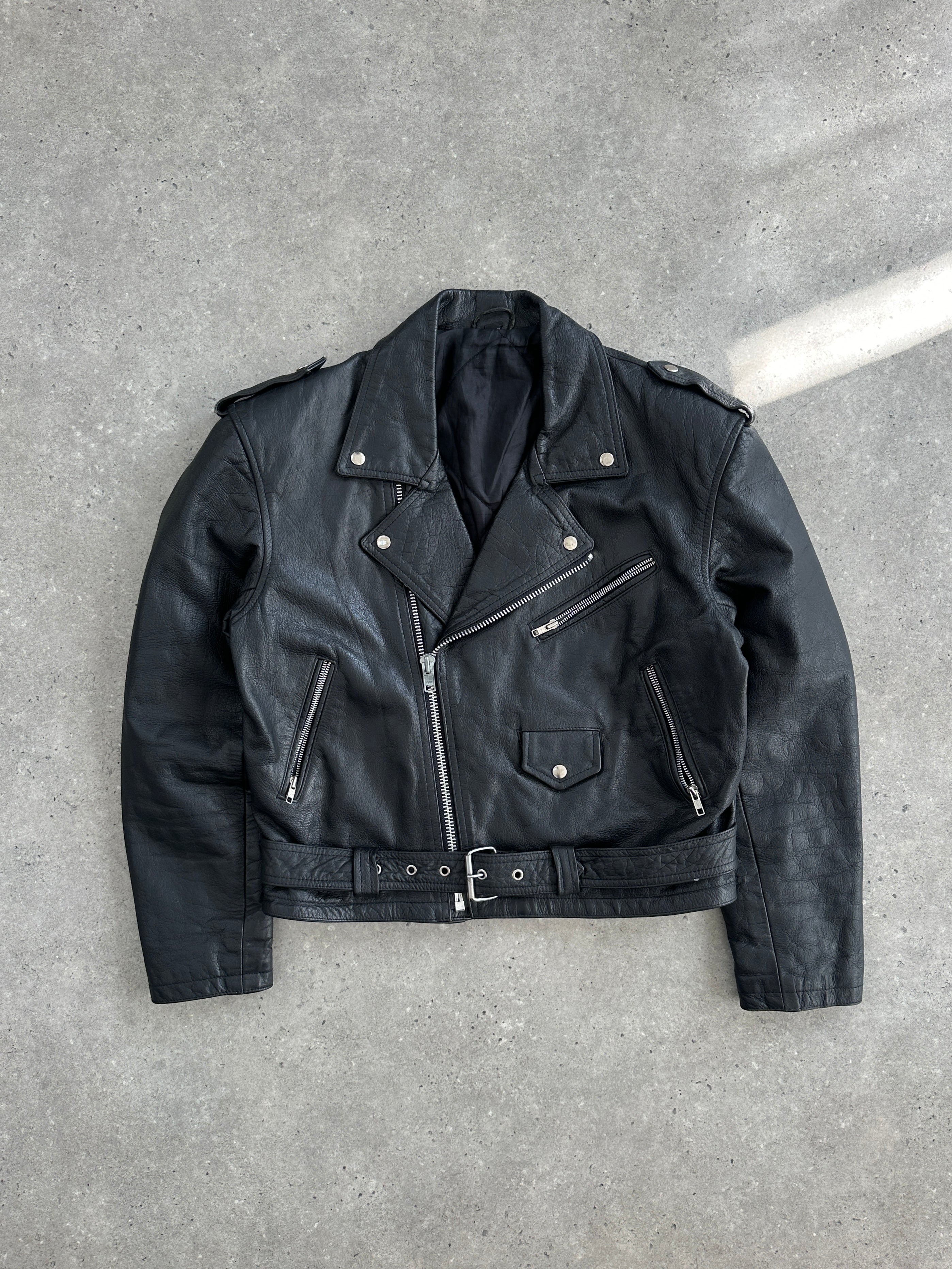 Vintage 1990s leather biker jacket in size large with classic distressed leather finish and rugged style.