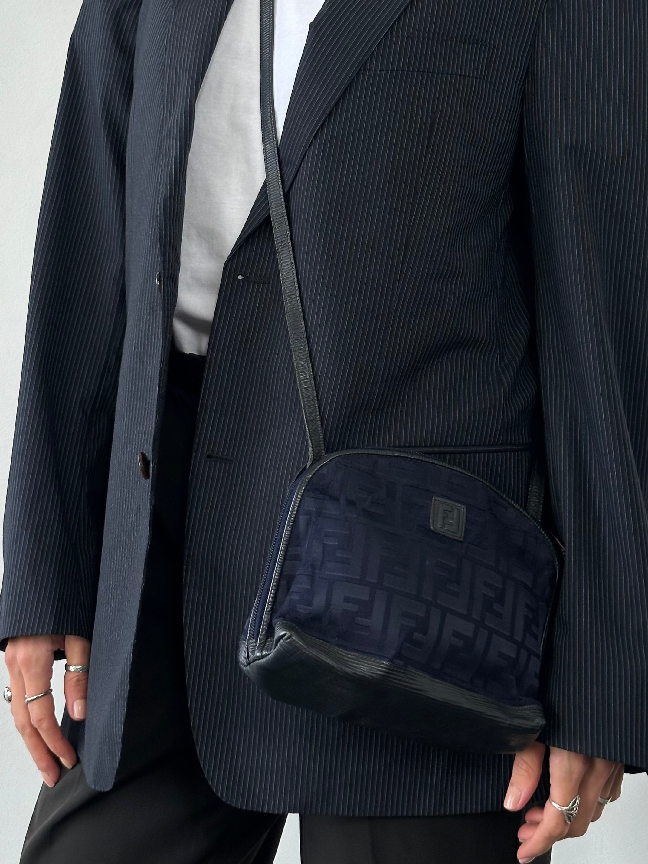 Fendi FF Monogram Crossbody Bag with adjustable strap and gold-tone hardware, showcasing signature logo pattern and sleek design.