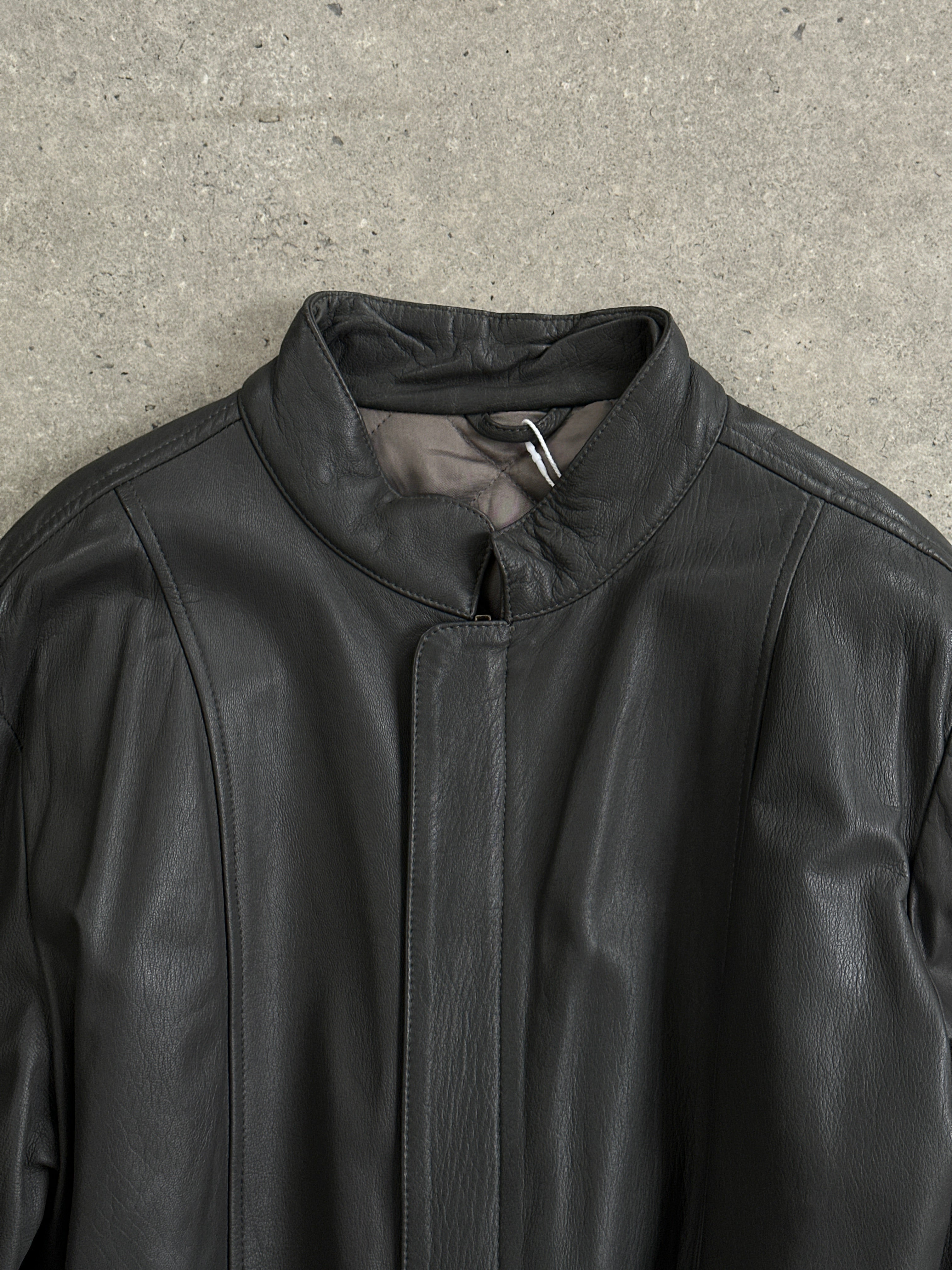 Vintage Italian leather belted jacket in XL with classic style and detailed stitching, displayed on a hanger.