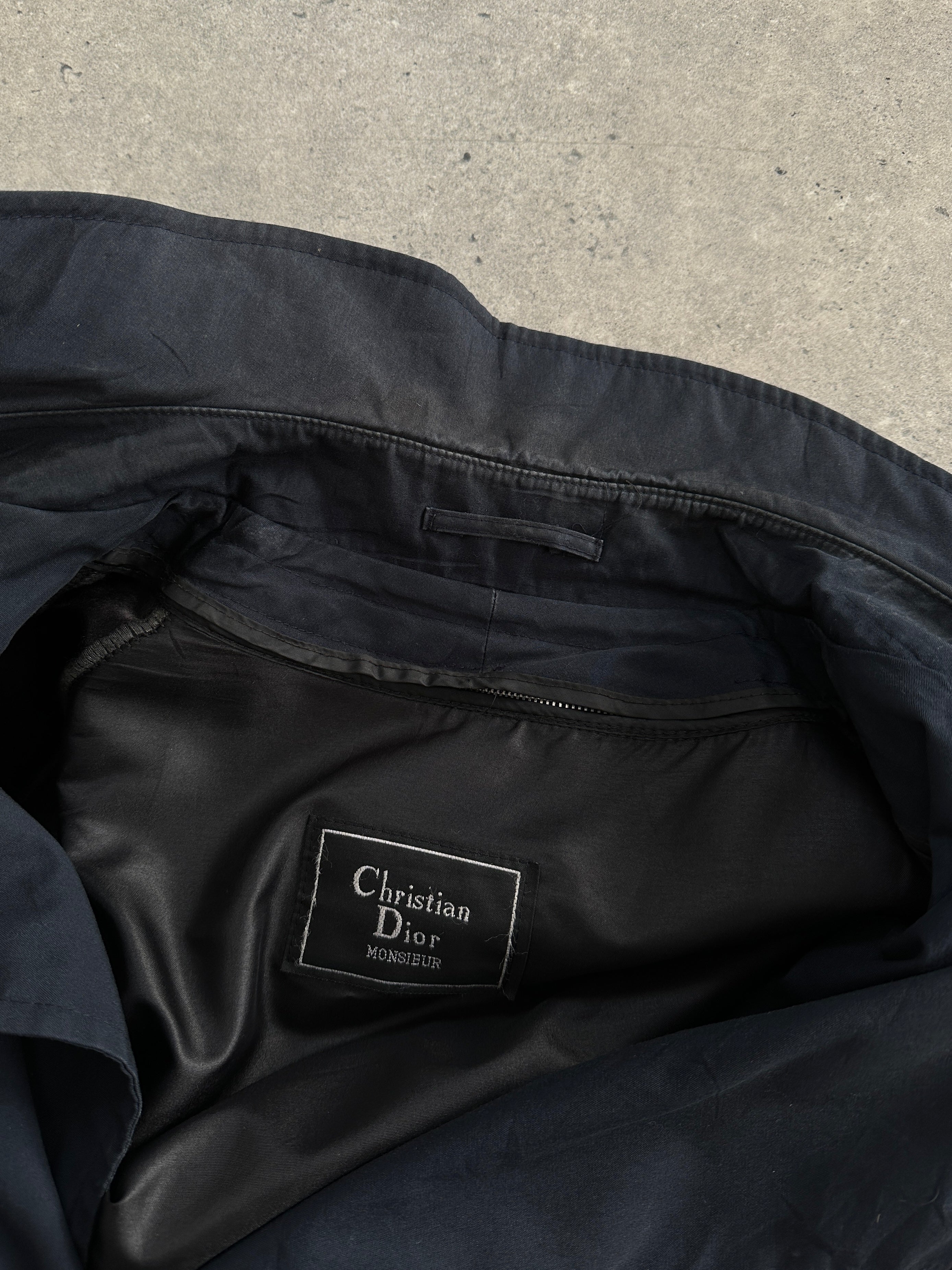 Christian Dior Monsieur double-breasted trench coat in XL, featuring classic design and tailored fit, displayed on a hanger.
