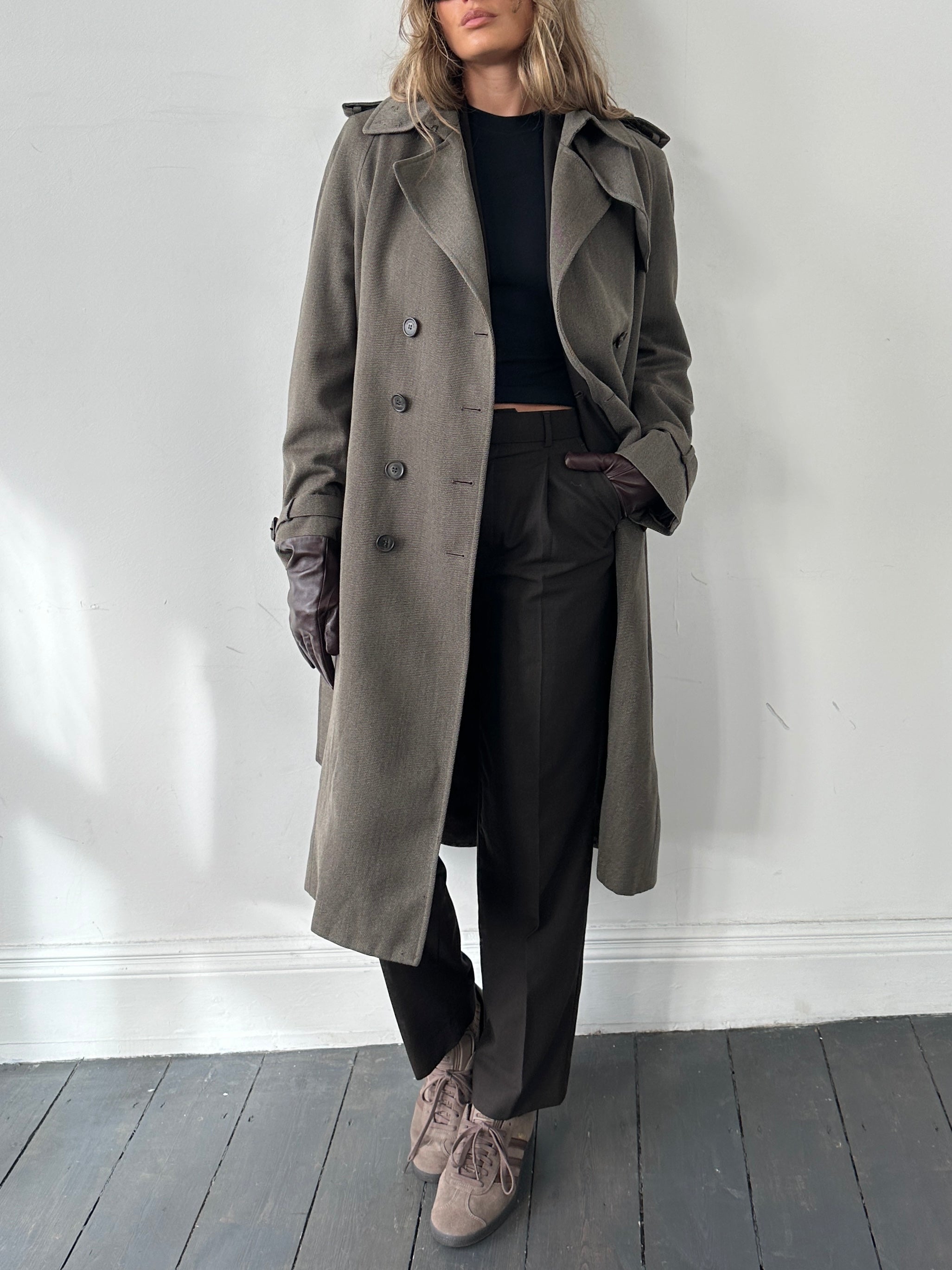 Burberry London wool double-breasted belted trench coat in beige, displayed on a hanger, showing classic design and tailored fit.