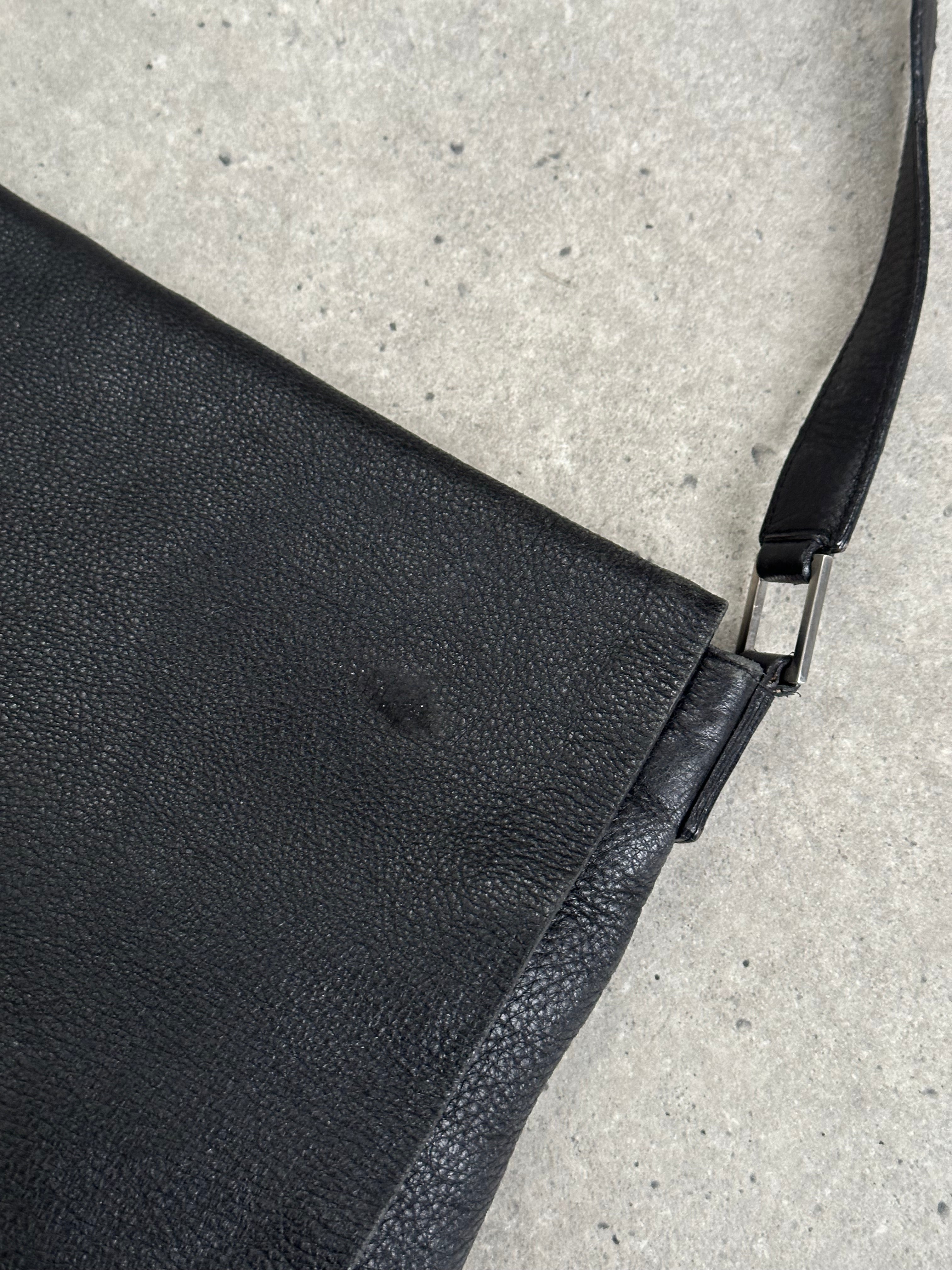 Giorgio Armani 2000s leather crossbody bag with adjustable strap and classic design, featuring a smooth leather finish.
