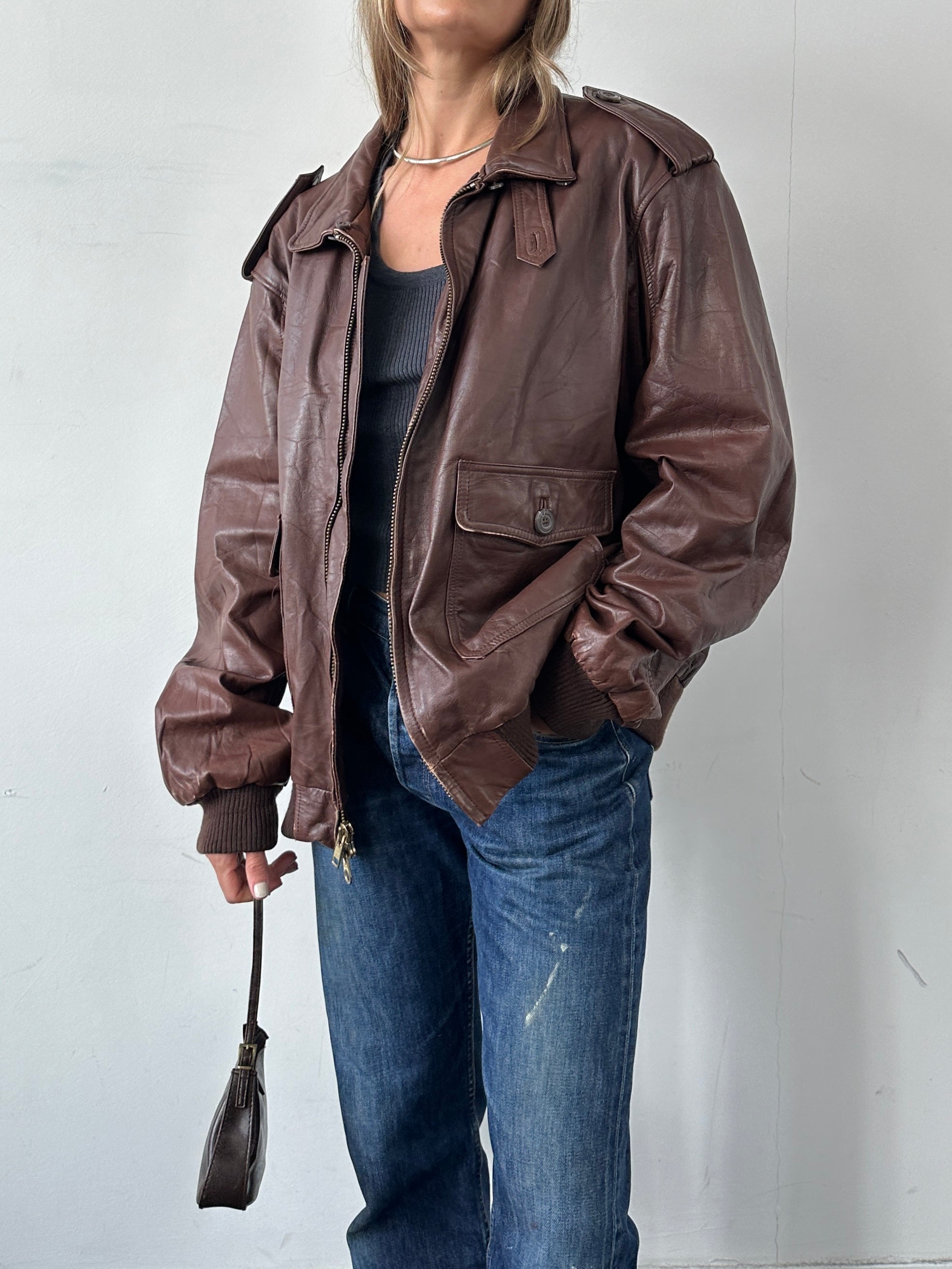 Vintage double zip leather bomber jacket in XL, featuring classic design, smooth leather, and zippered front pockets.