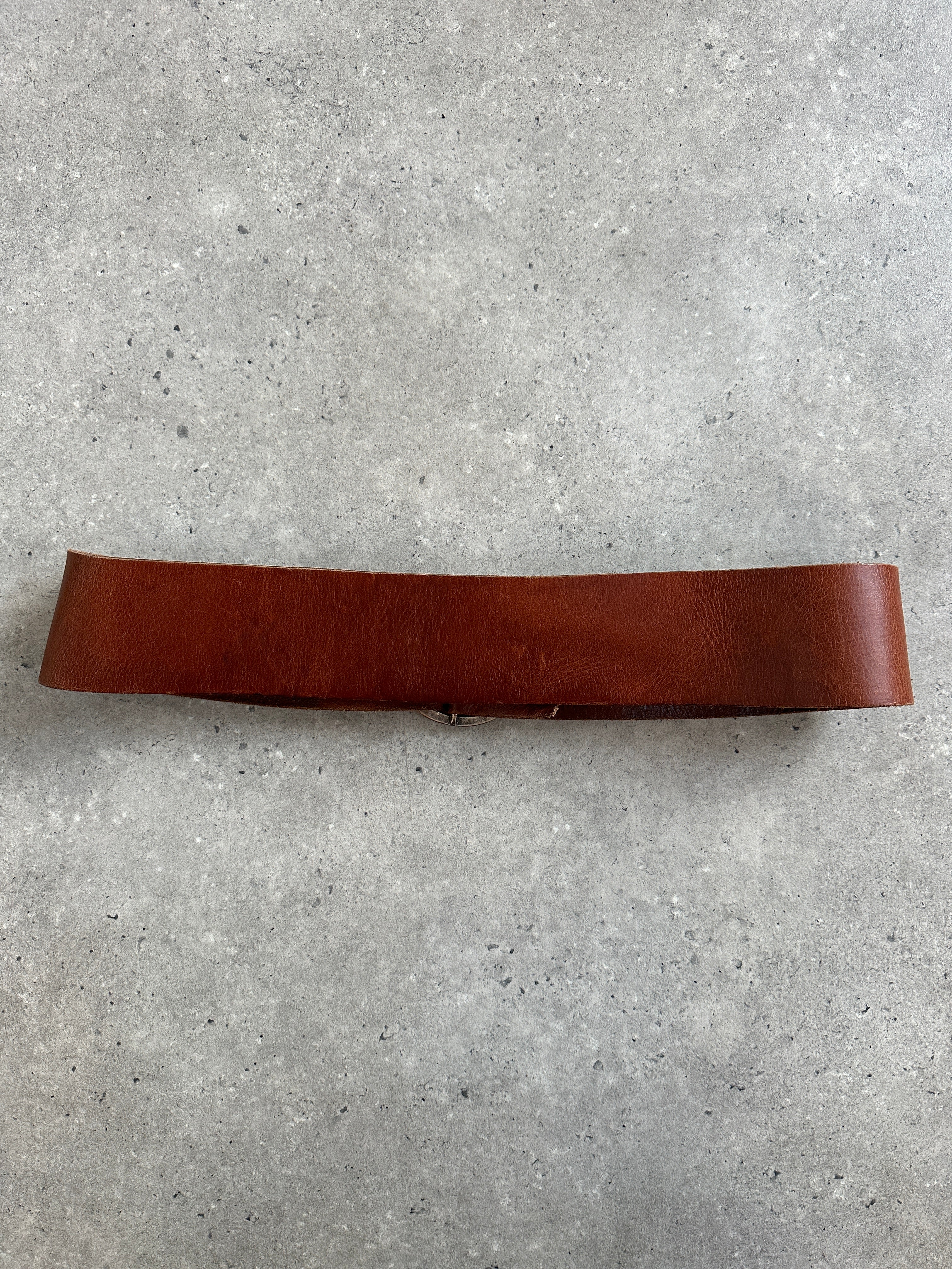Vintage 1990s round leather chunky belt with brass buckle, in brown, showing textured leather and retro style.
