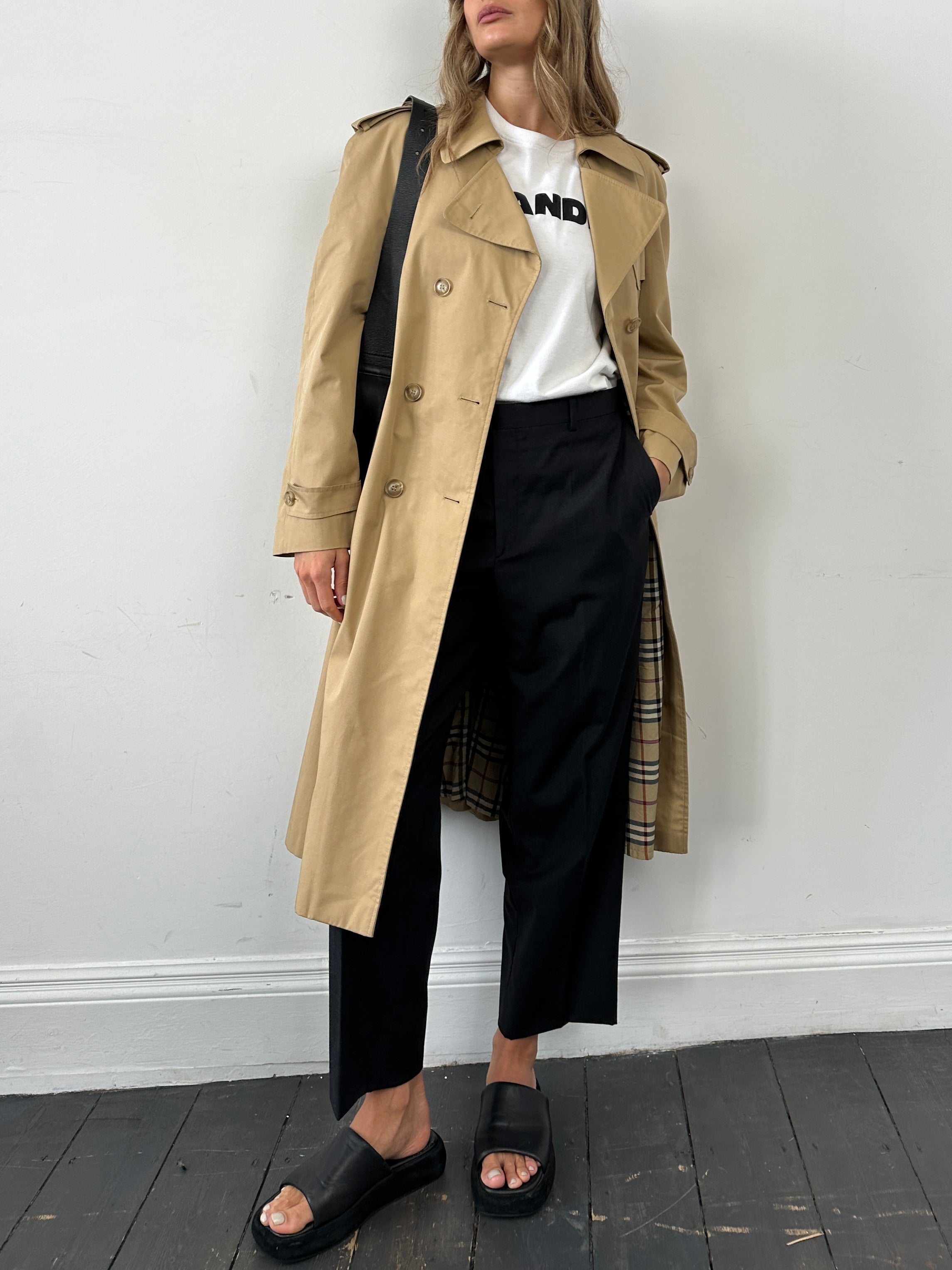 Vintage cotton double-breasted belted trench coat, size L, with classic design and button details, shown on a hanger.