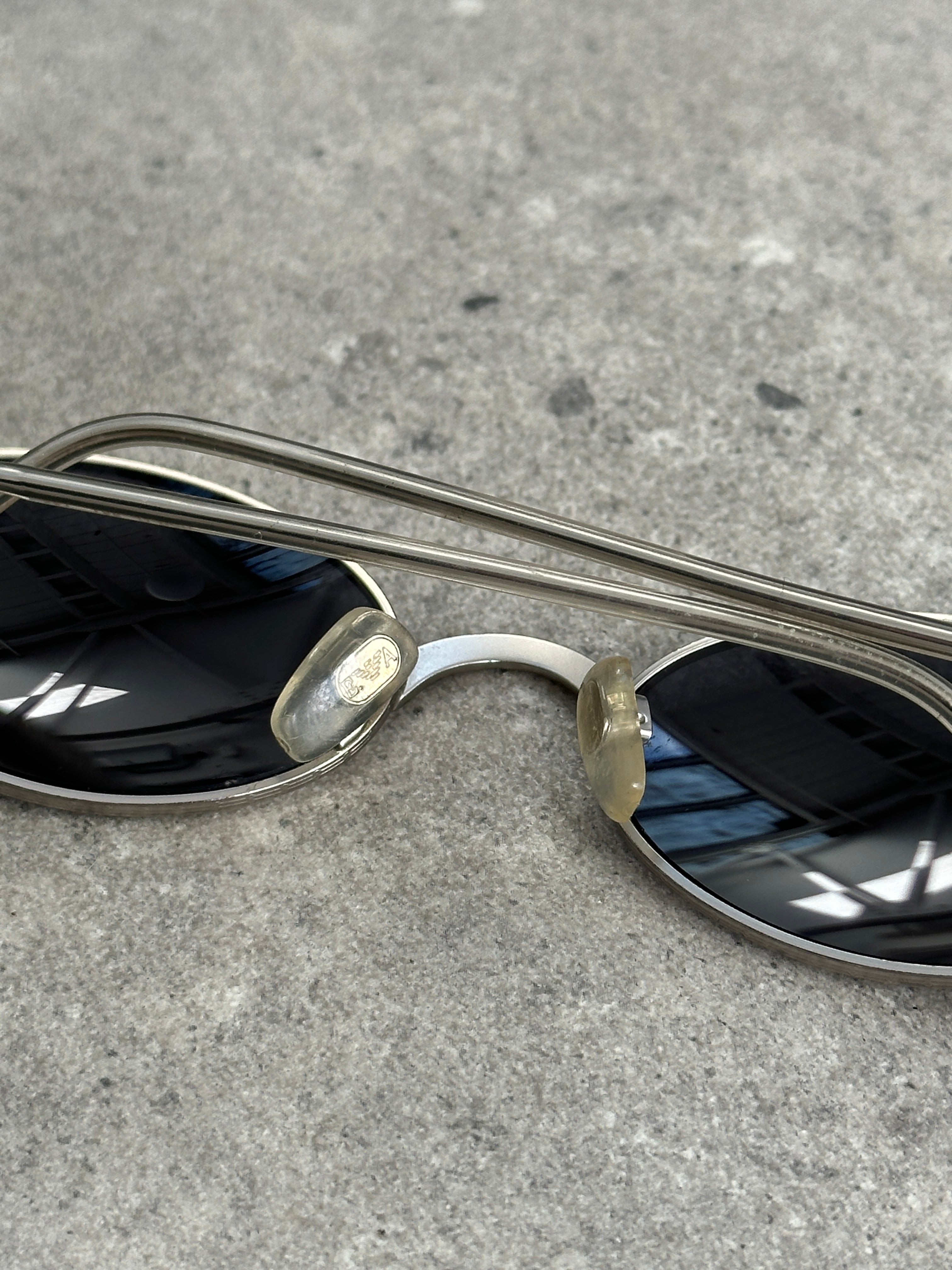 Emporio Armani metal oval sunglasses with sleek frame and dark tinted lenses, stylish and modern eyewear.