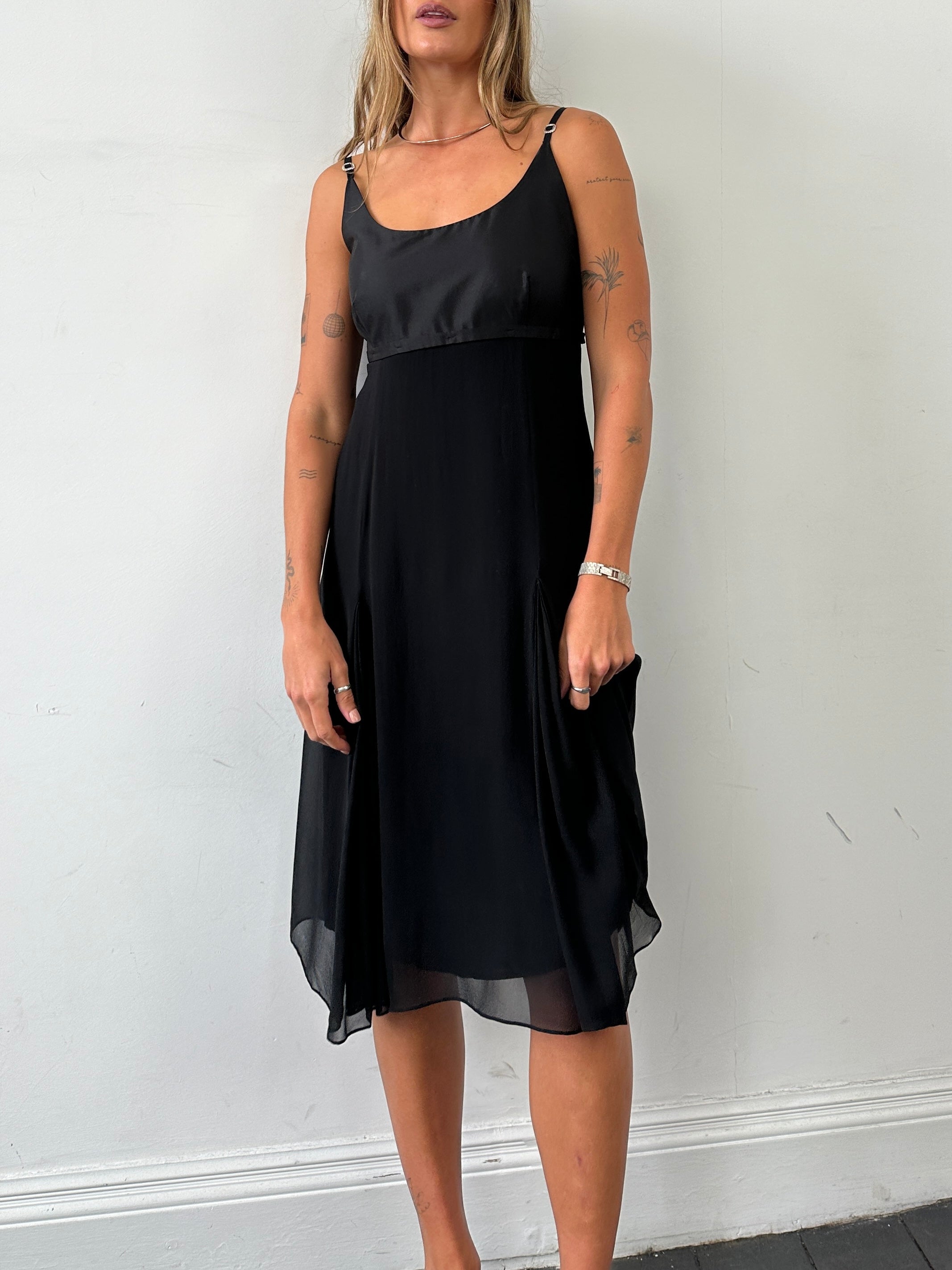 Max Mara pure silk pleated midi dress in light fabric with a fitted waist and elegant drape, displayed on a mannequin.