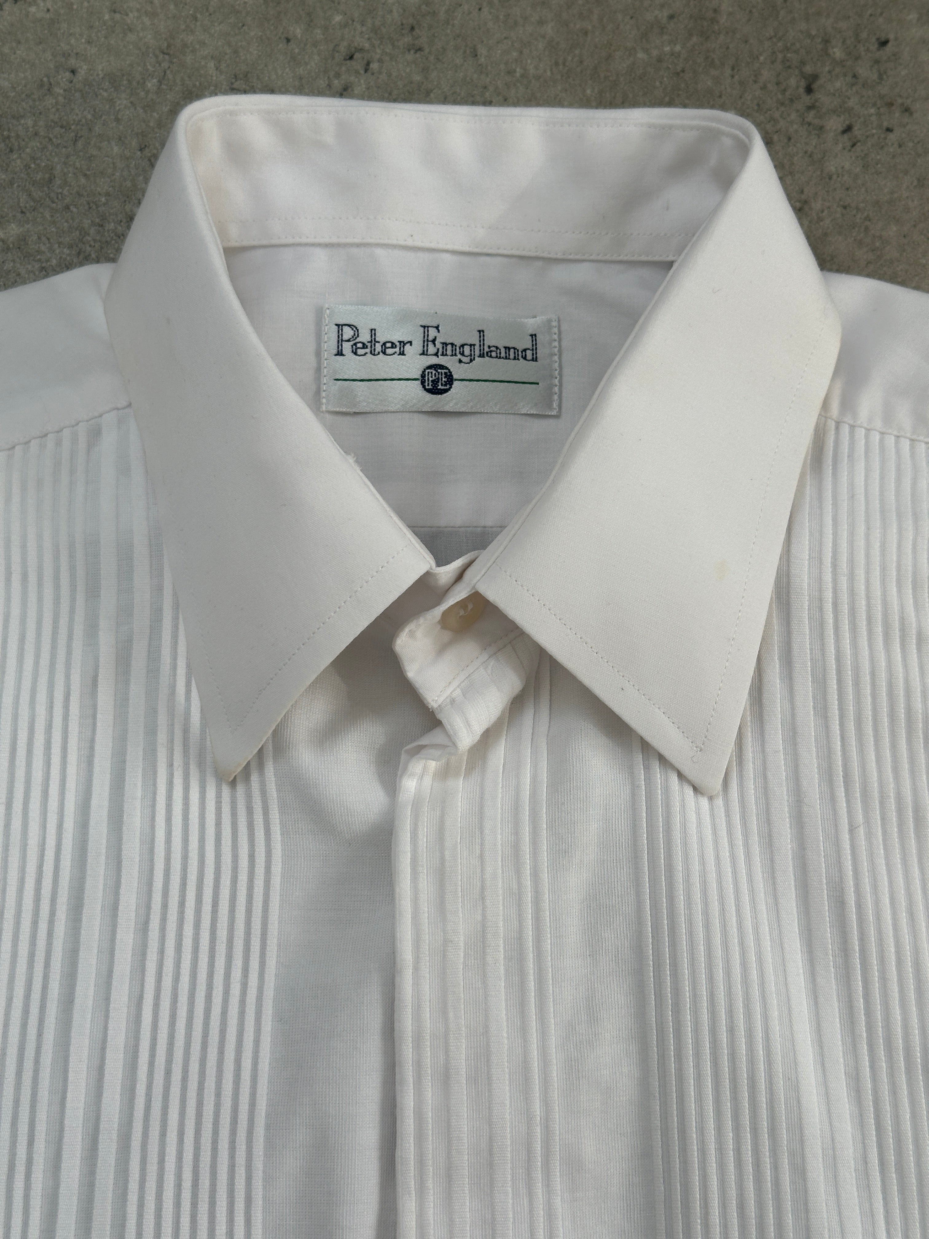 Vintage cotton tuxedo dress shirt in size large, featuring classic design and crisp collar, displayed on a hanger.