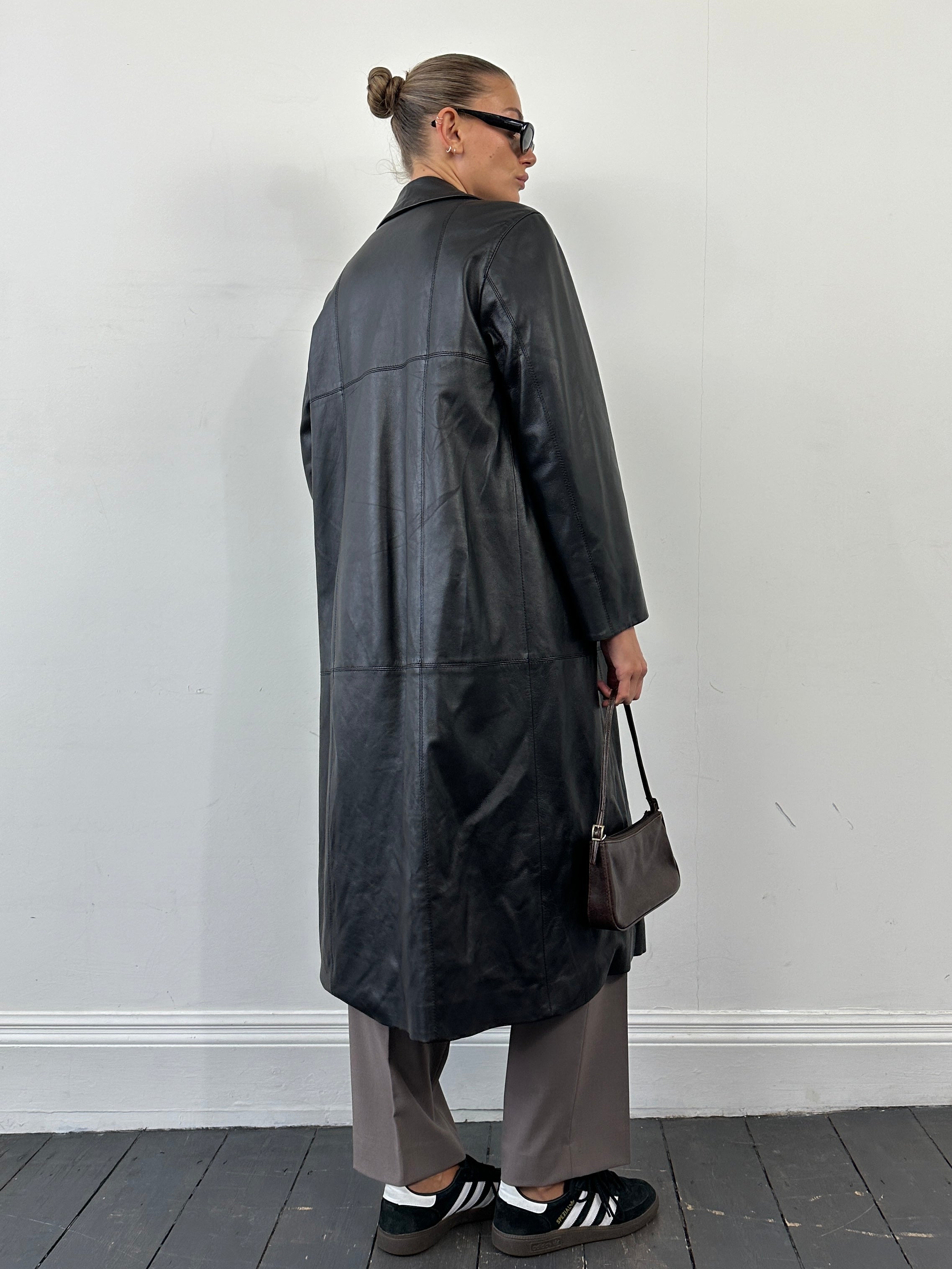 Conbipel smooth leather trench coat in size L, stylish jacket with a sleek design and classic collar, displayed on a hanger.