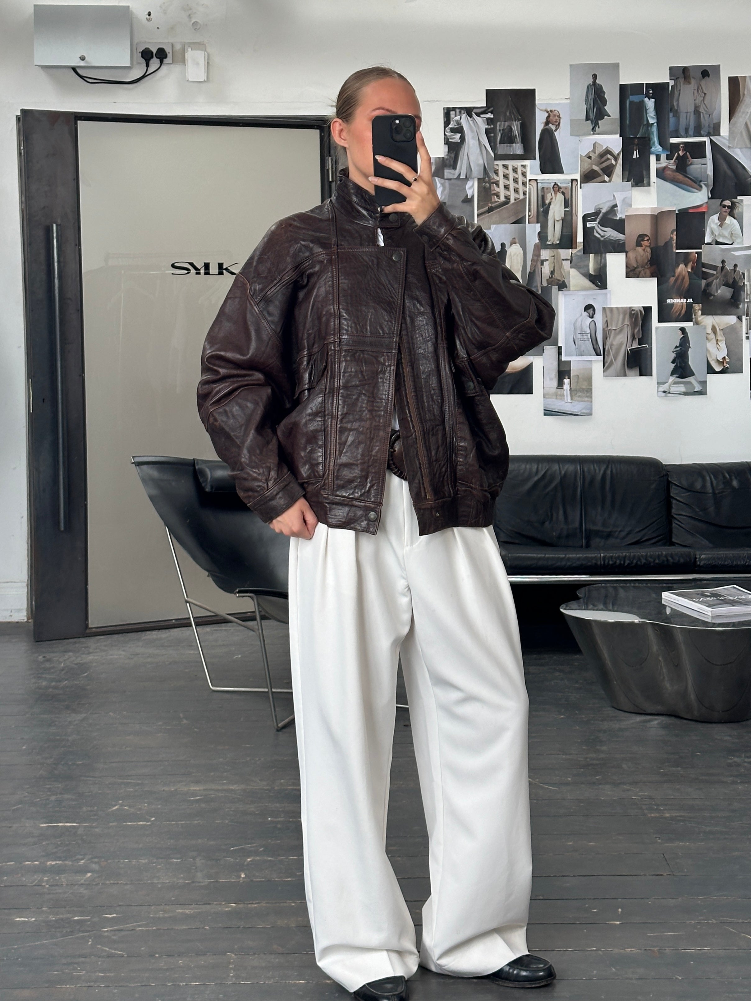 Vintage 1970s high neck leather bomber jacket in XL, featuring classic moto style with a rugged leather finish and vintage branding.