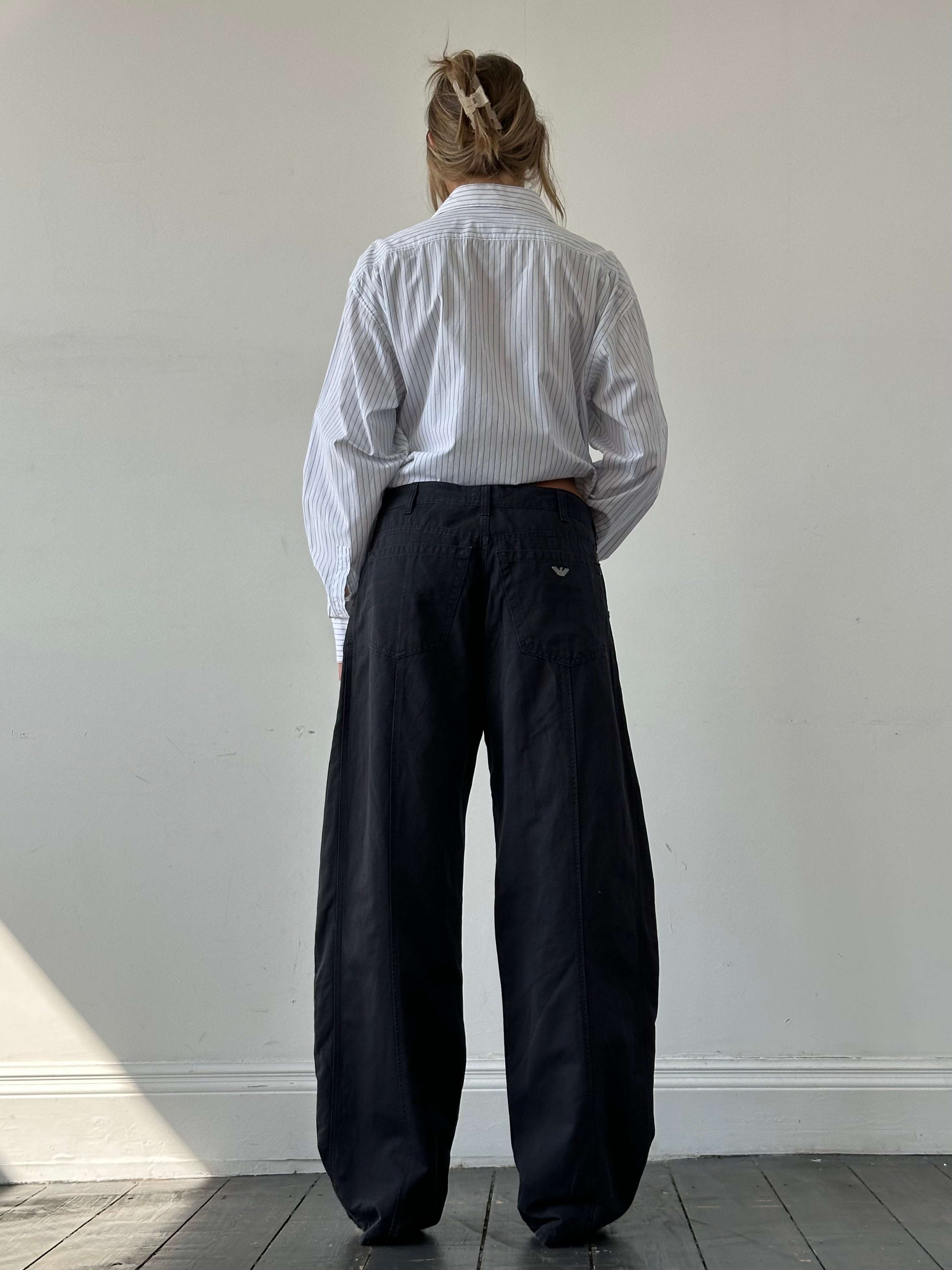 Armani Jeans cotton wide-leg trousers in size W32, shown in a natural pose highlighting the relaxed fit and fabric details.
