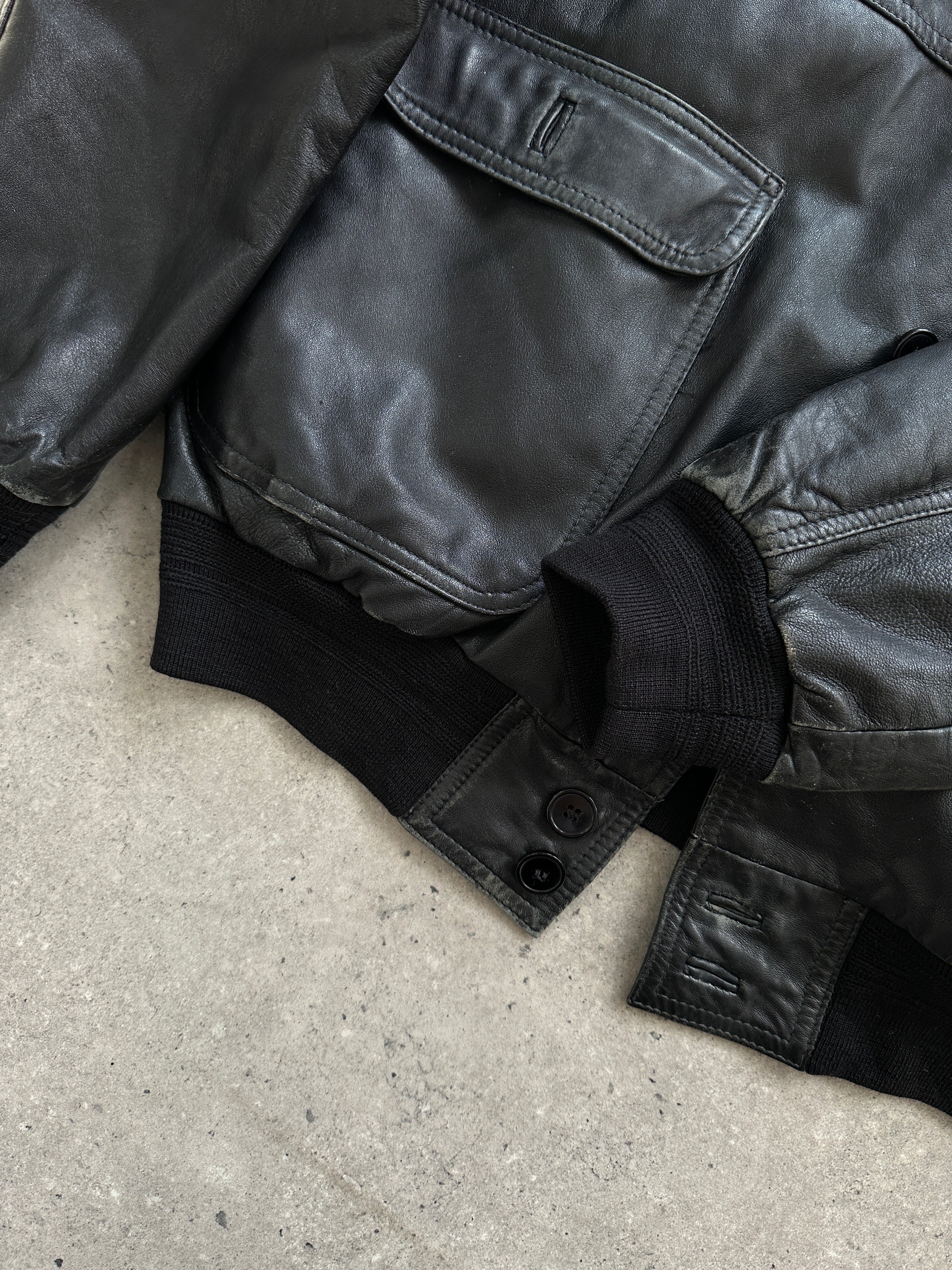 Vintage leather bomber jacket with classic design, shown in medium size, featuring a rugged, stylish look from the Vintage brand.