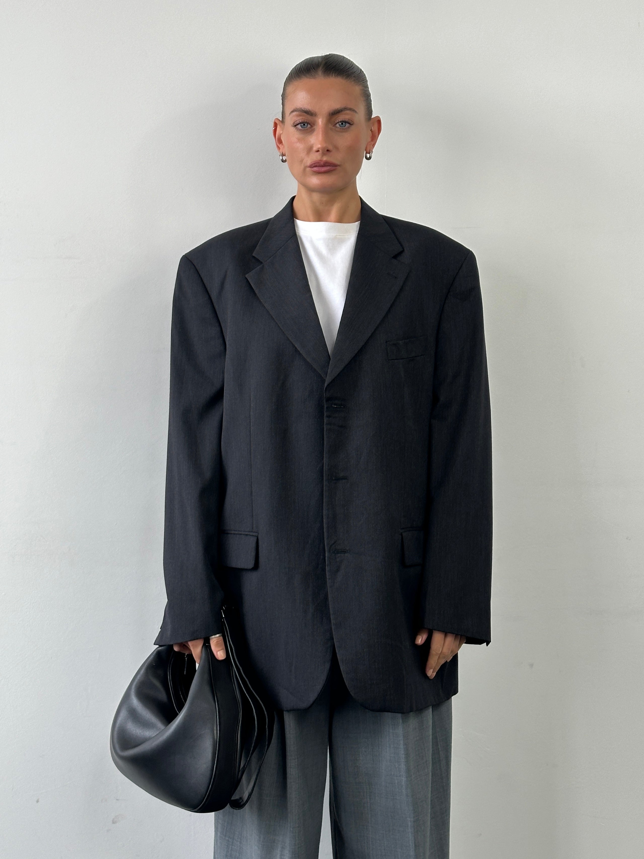 Yves Saint Laurent Pour Homme 1990s pure wool single-breasted blazer in size 48R/XXL, displayed on a hanger with classic tailoring.