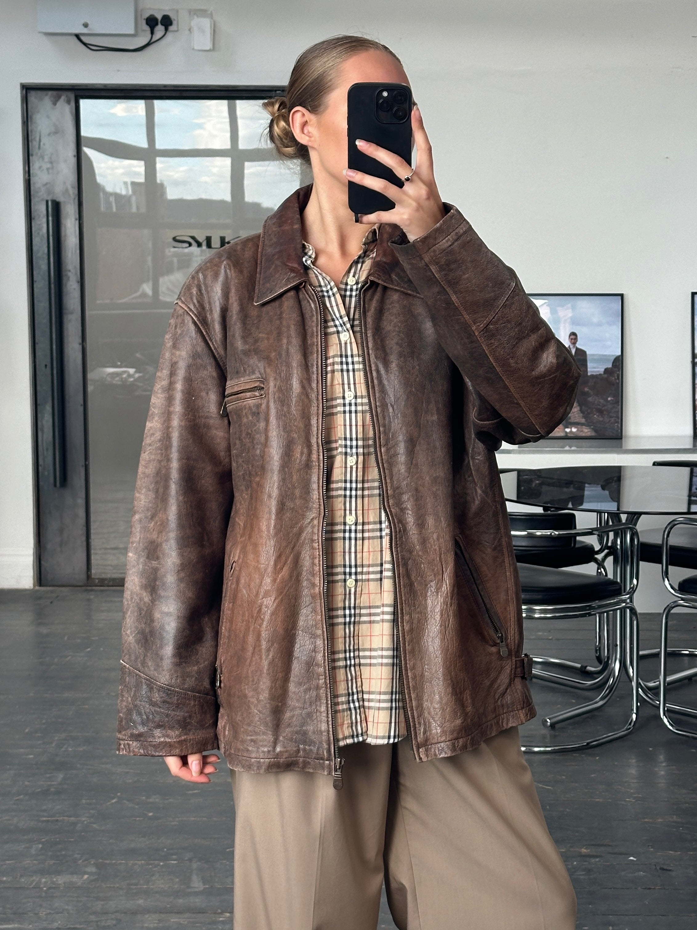 Vintage 1990s aged leather jacket in XL, showcasing distressed brown leather with classic design and rugged style.
