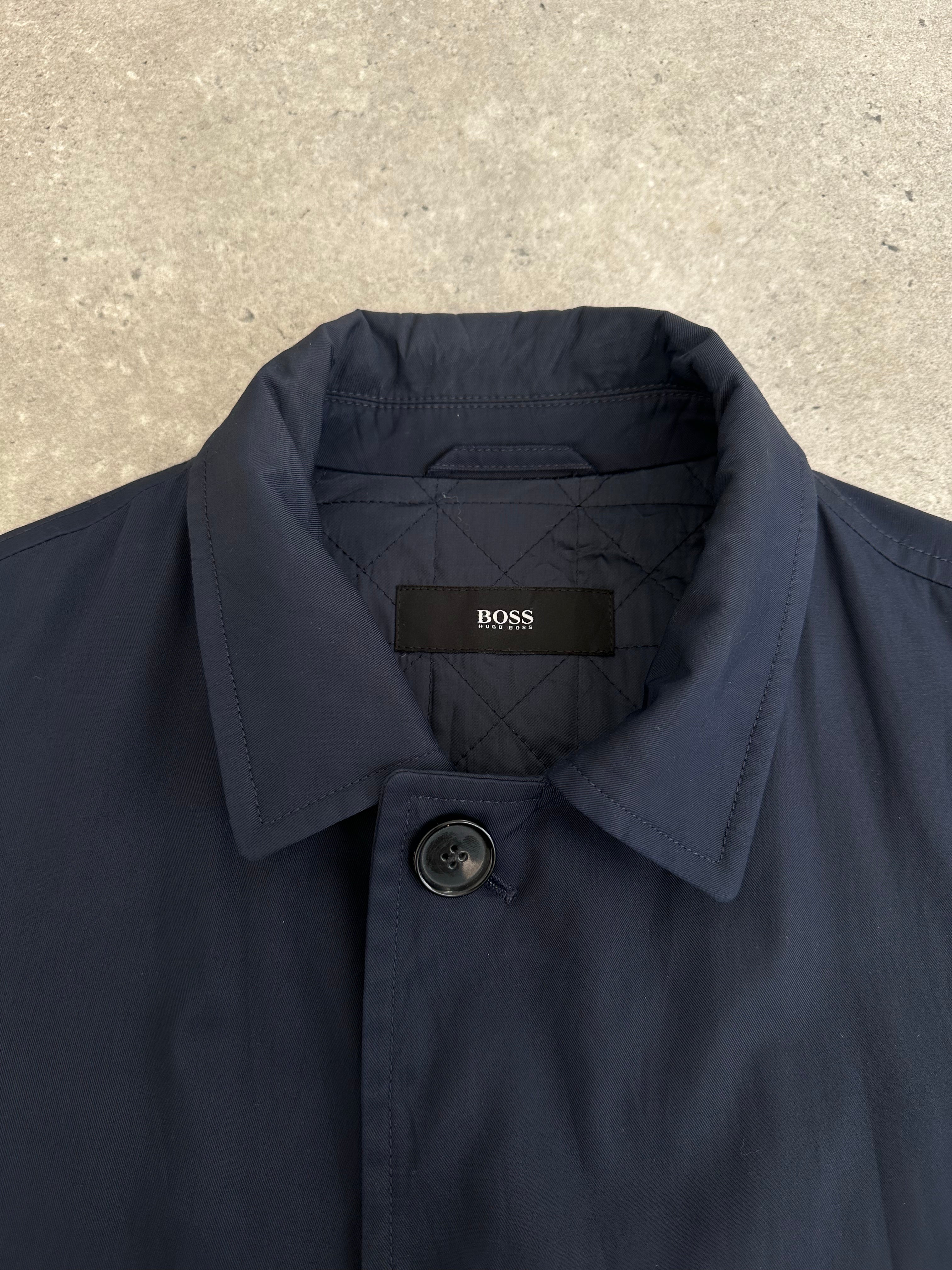 Hugo Boss 2000s cotton water-repellent trench coat in size L, shown in a classic beige color with a waist belt and button details.