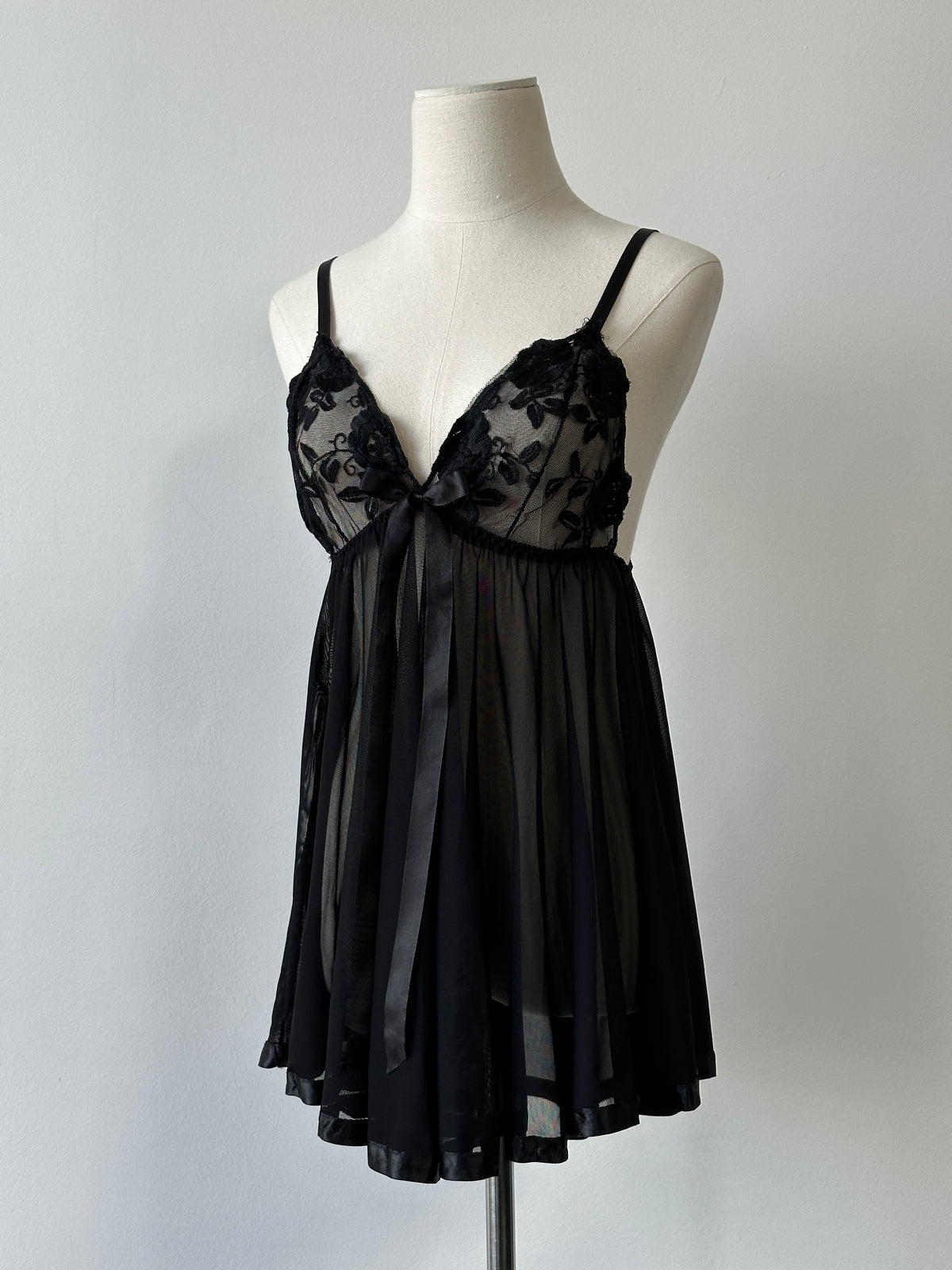 Vintage 2000s sheer lace babydoll top in black, featuring delicate floral patterns and a flowy, feminine silhouette.