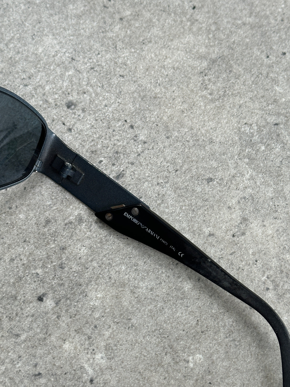 Emporio Armani 1990s oval logo sunglasses with dark tinted lenses and sleek black frames.