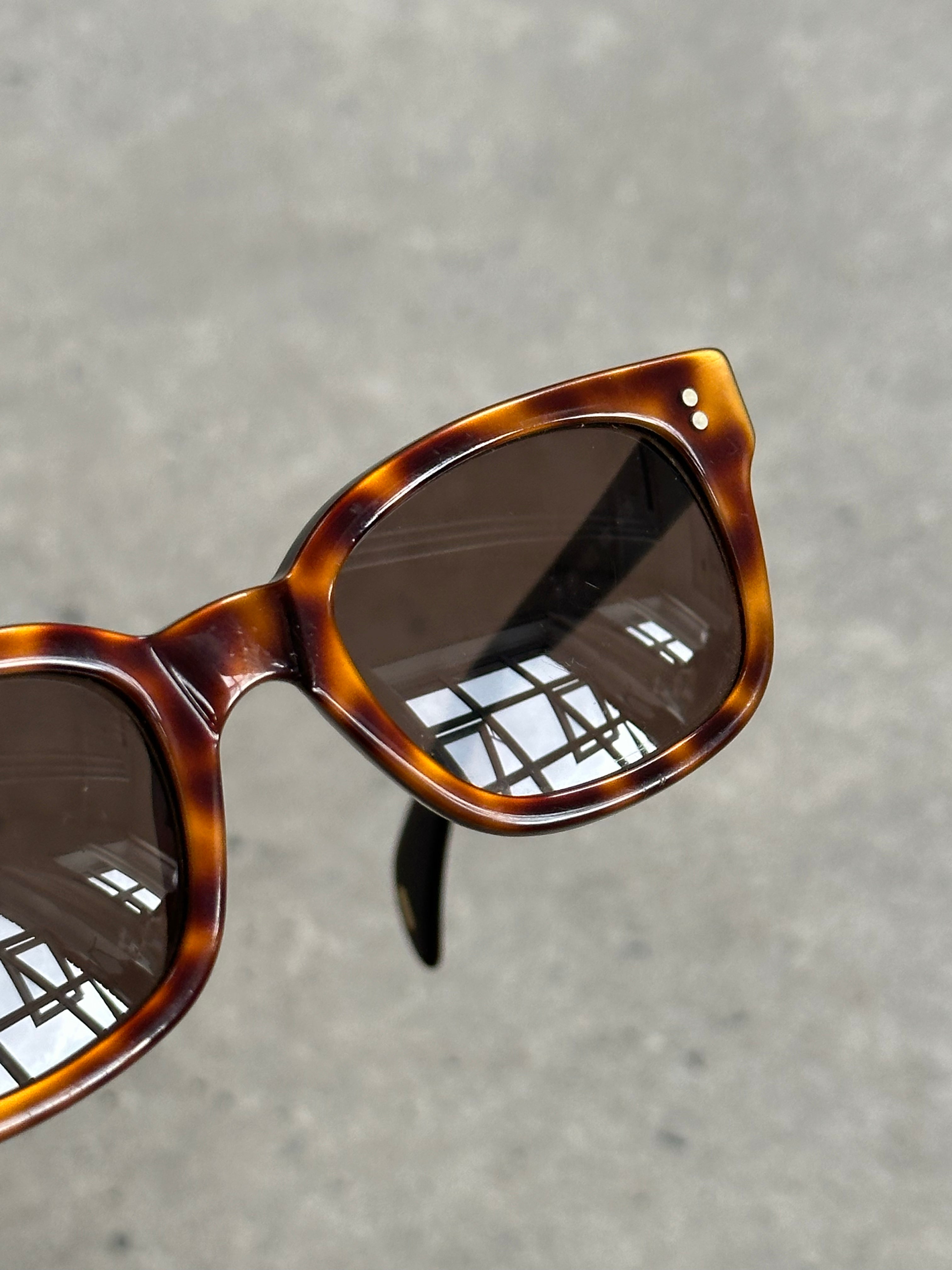 Gucci 2000s Tom Ford tortoiseshell rectangle logo sunglasses with dark tinted lenses and bold frame details.