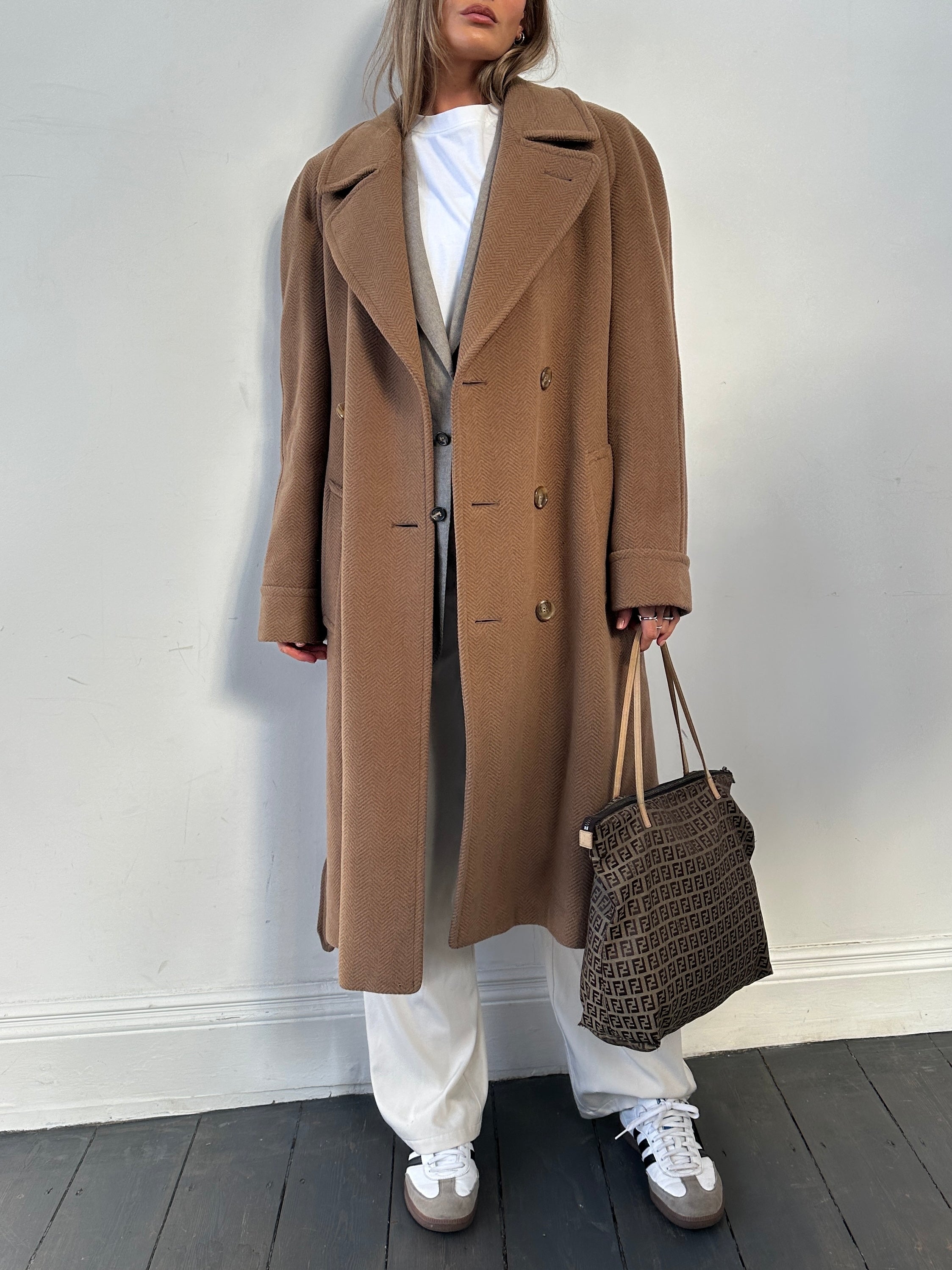 Christian Dior belted double-breasted wool coat in size L, featuring classic design and tailored fit, displayed on a hanger.