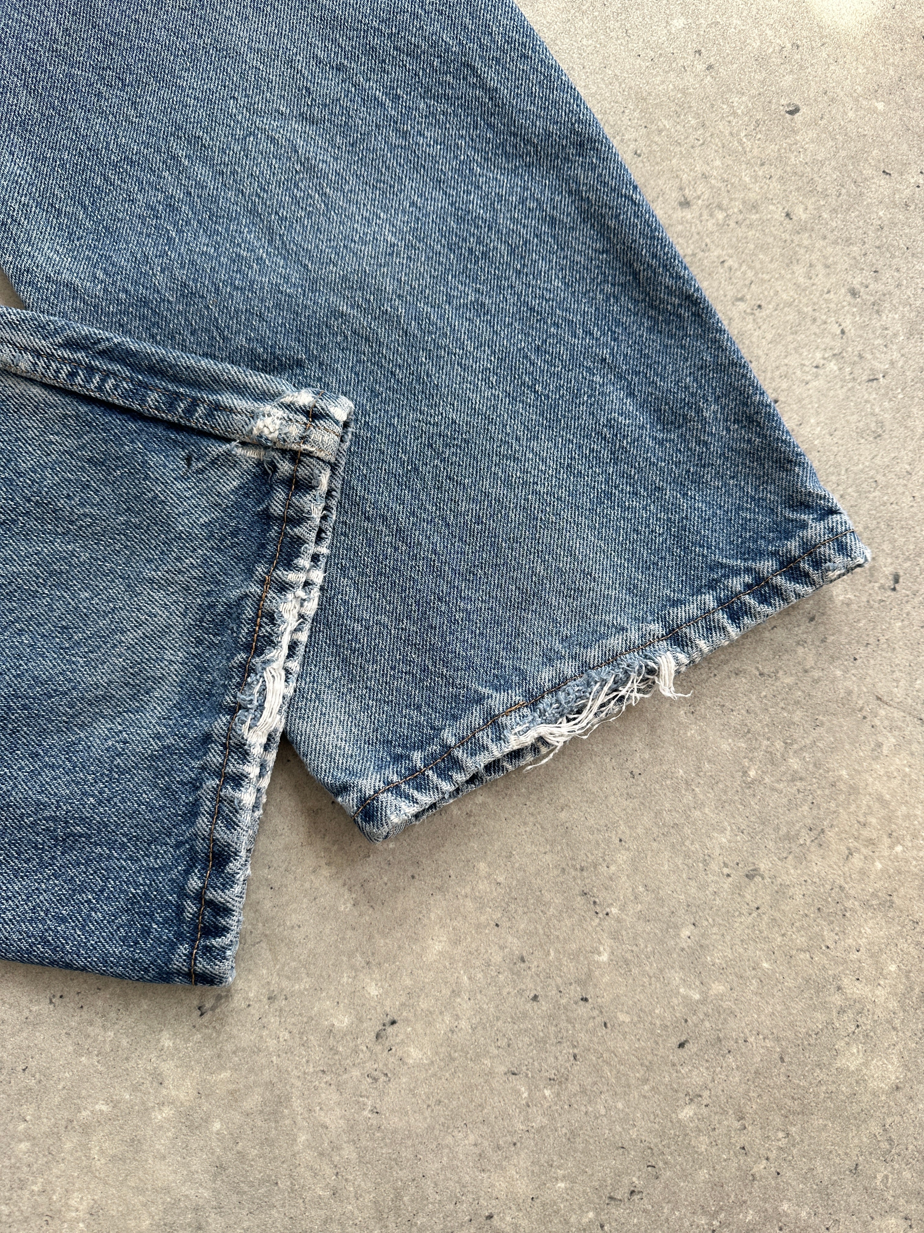 Wrangler mid wash straight leg high waisted denim jeans, size W28, showing front view with classic stitching and fit details.