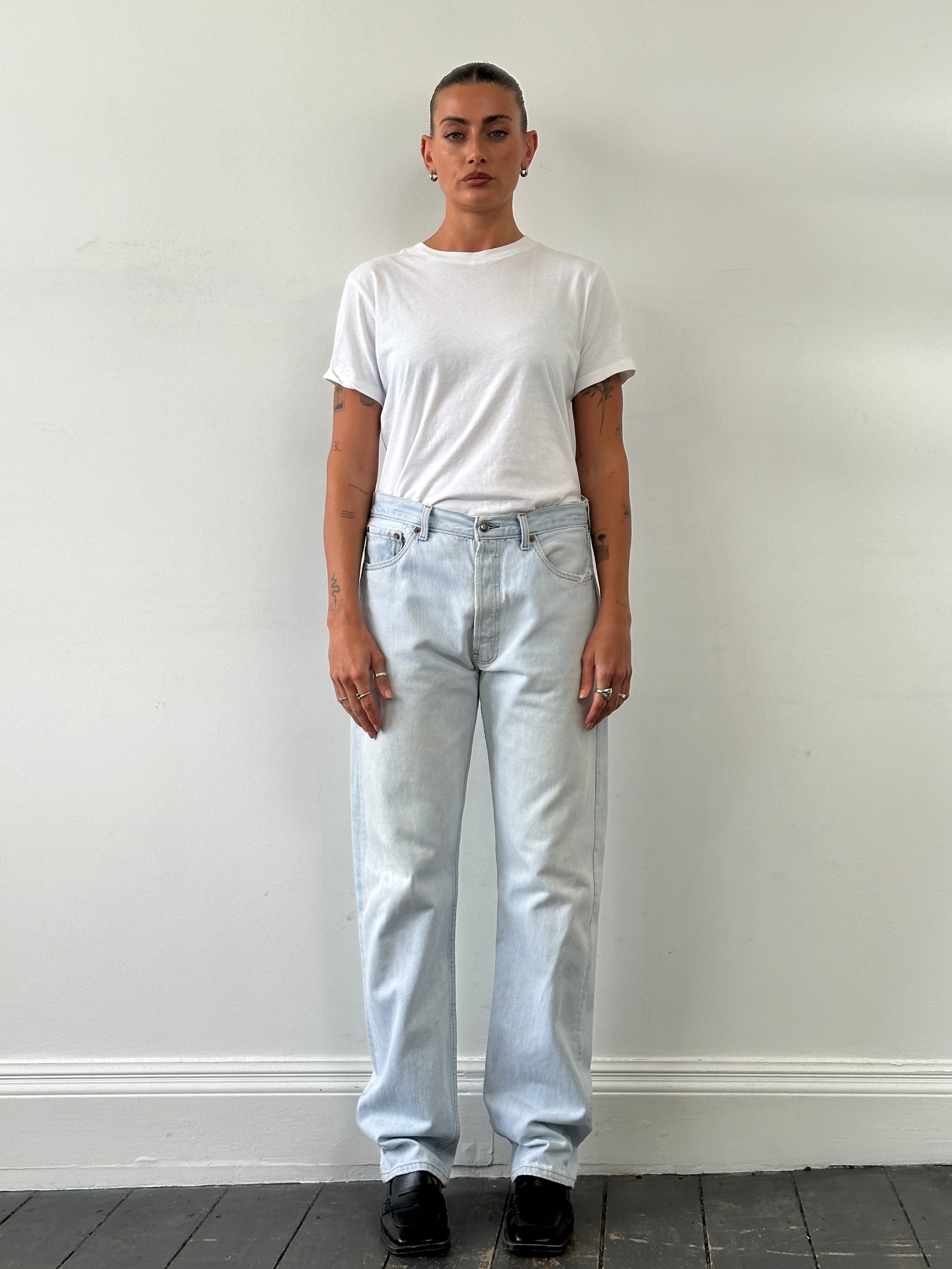 Levi’s 501 light wash straight leg denim jeans in W30, showing classic fit and button fly on a hanger.