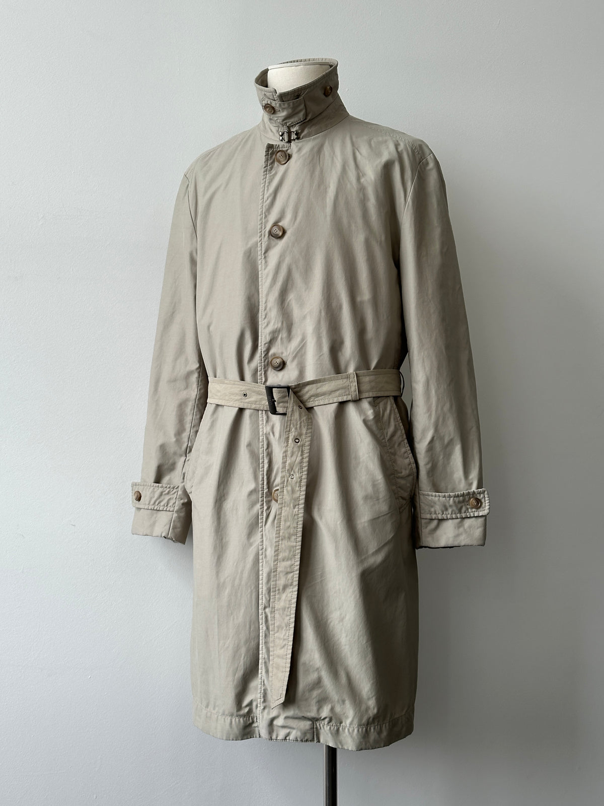 Hugo Boss 2000s high neck belted trench coat in beige, featuring a classic collar, waist belt, and long sleeves.