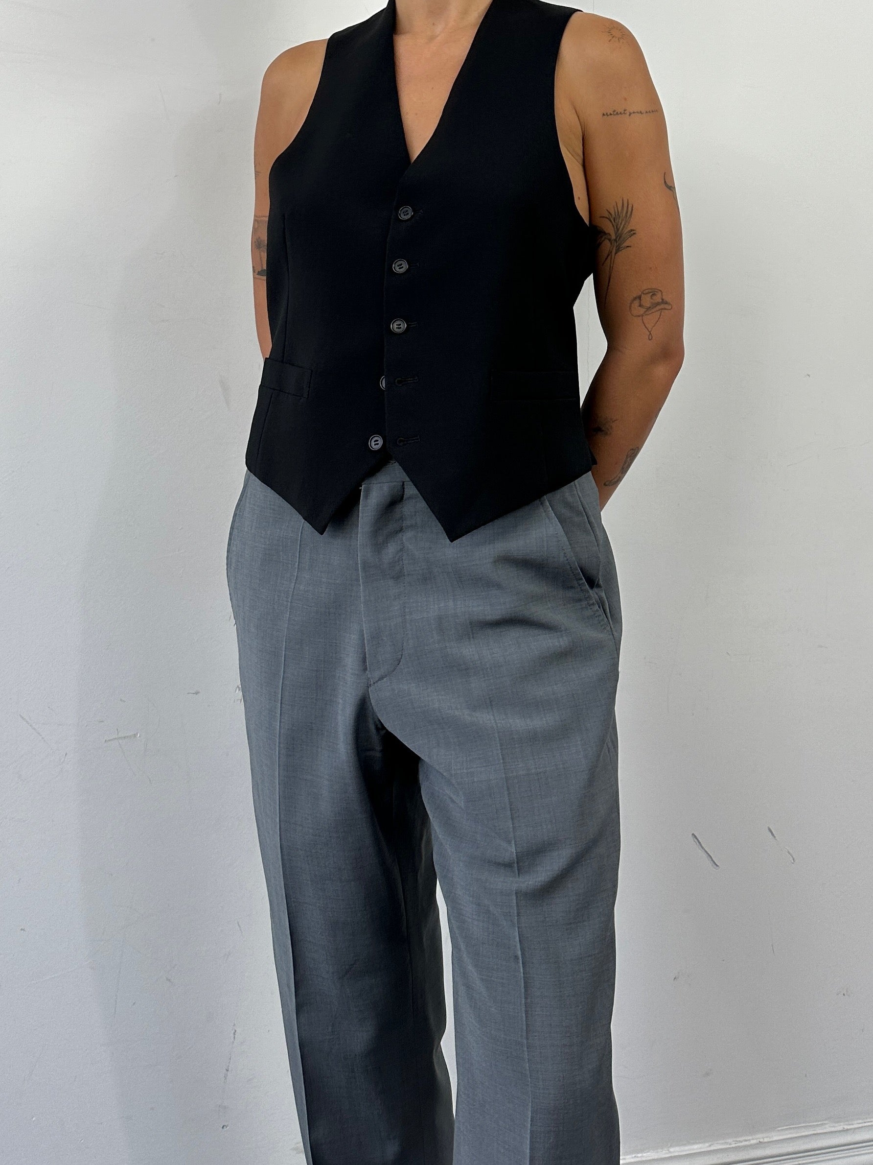 Vintage pure wool tailored waistcoat in size L, classic design with button closure and fitted silhouette.